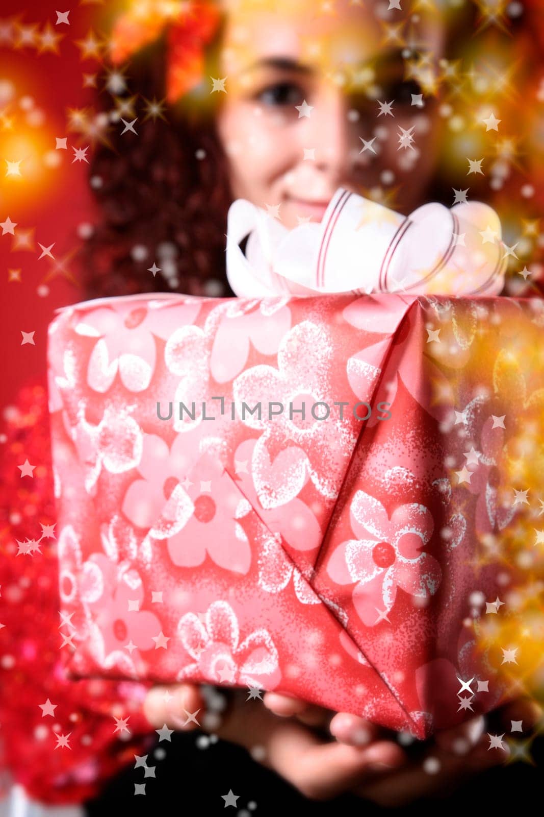 woman with a gift in her hands and snowflakes