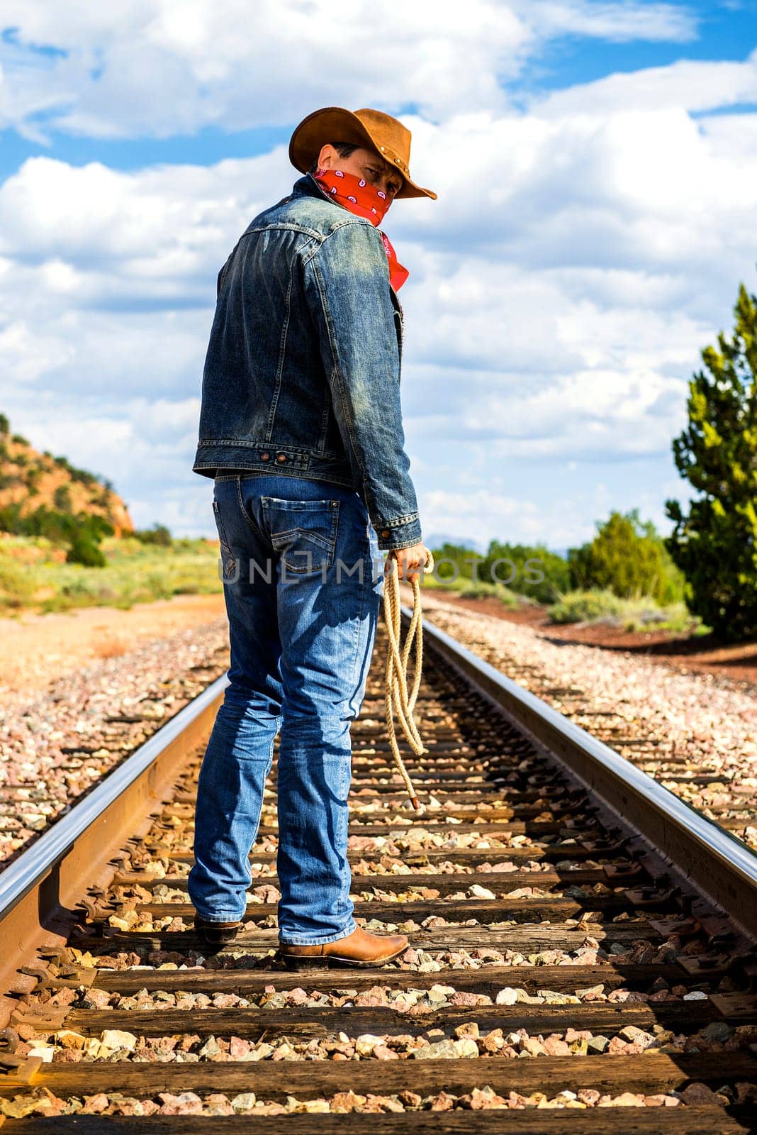 famous cow-boy boots and feets across train tracks
