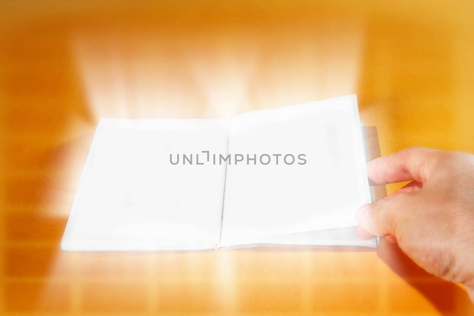 Opened empty photo album isolated on orange.