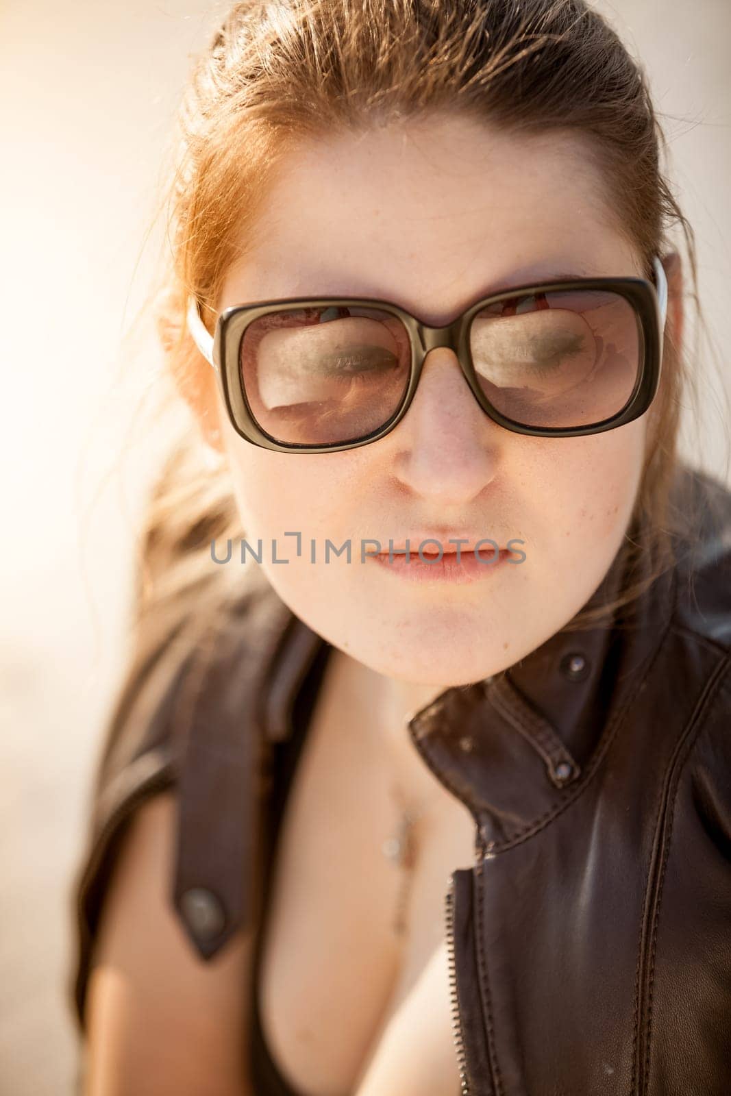 Closeup portrait of beautiful woman in sunglasses at desert