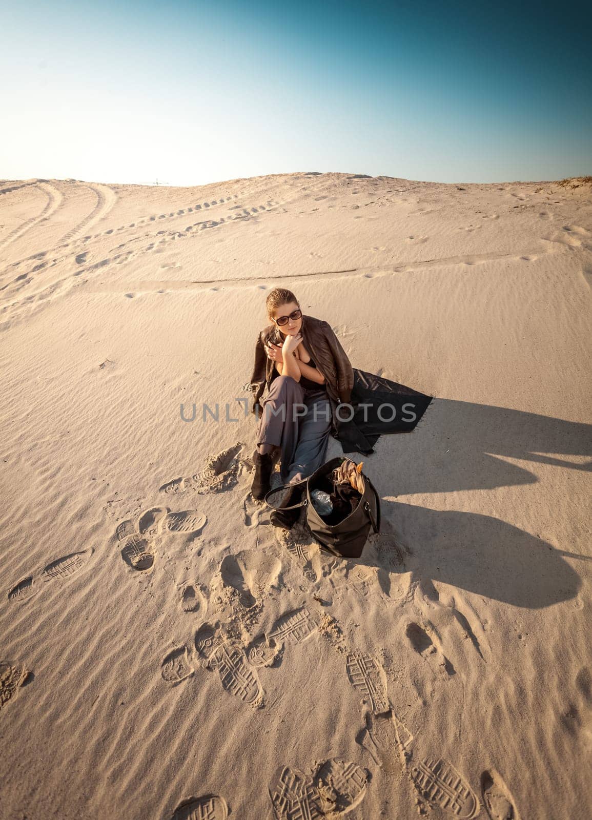 Photo of woman with bag lost in desert