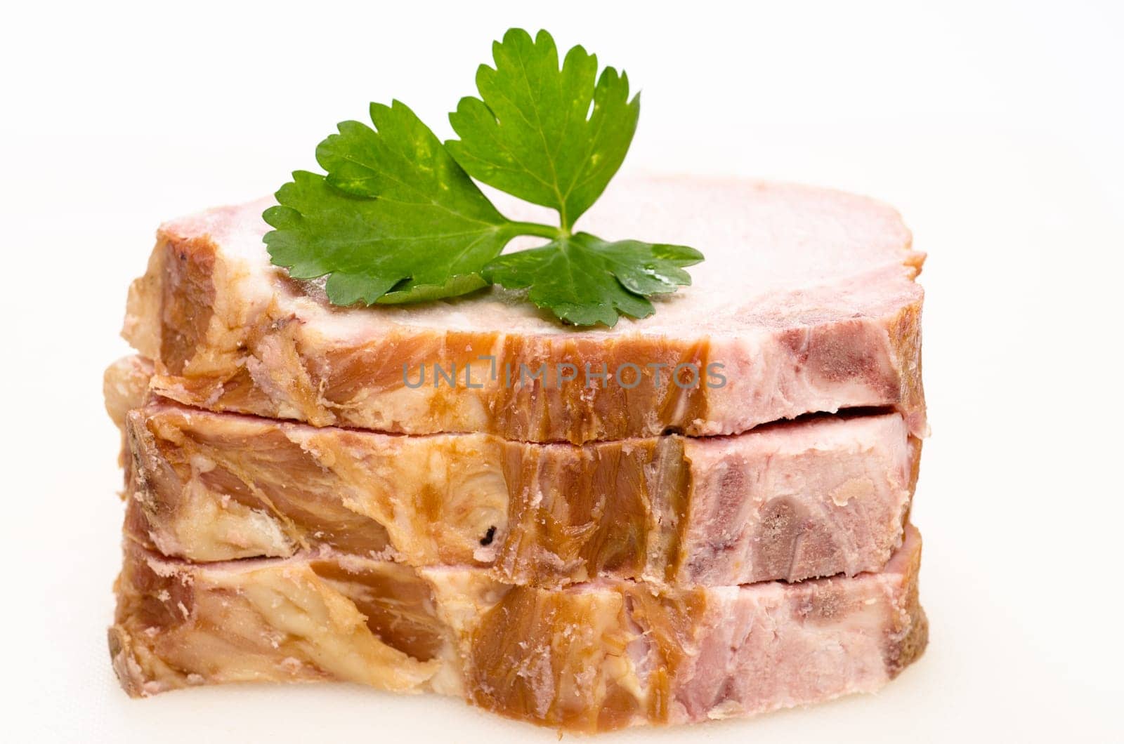 Three slices of Kassel meat with green parsley