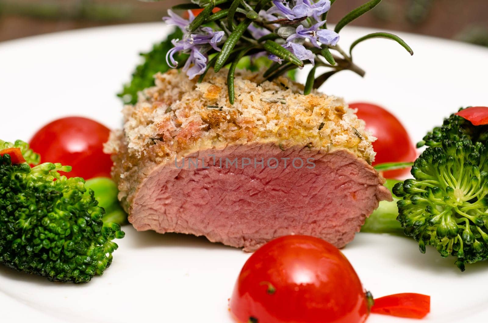 Roasted lamb back fillet with thyme and tomatoes