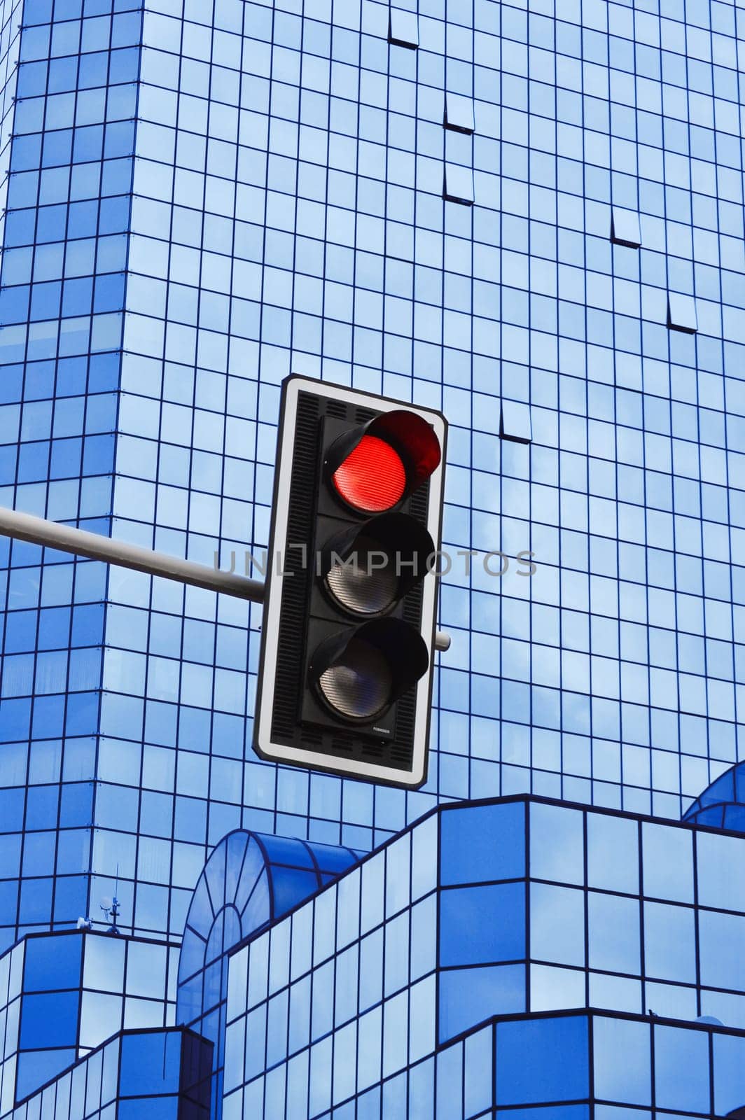 Traffic lights over modern business architecture