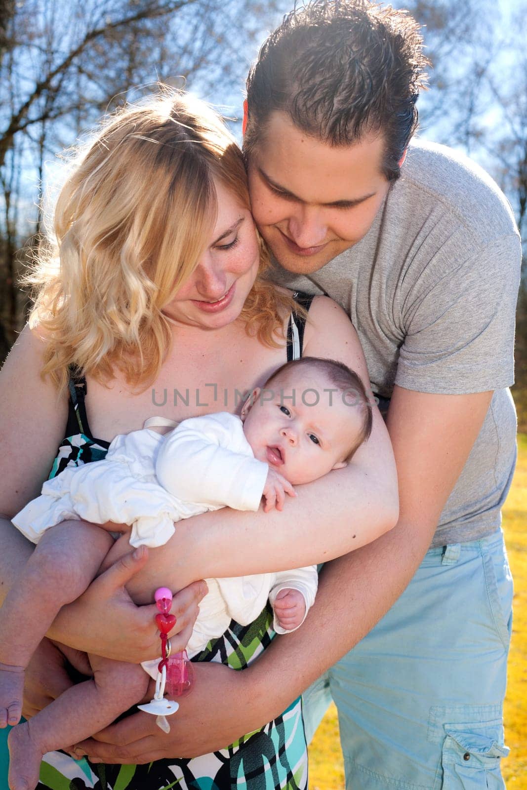 Young family is having  nice time with their baby on a sunny day
