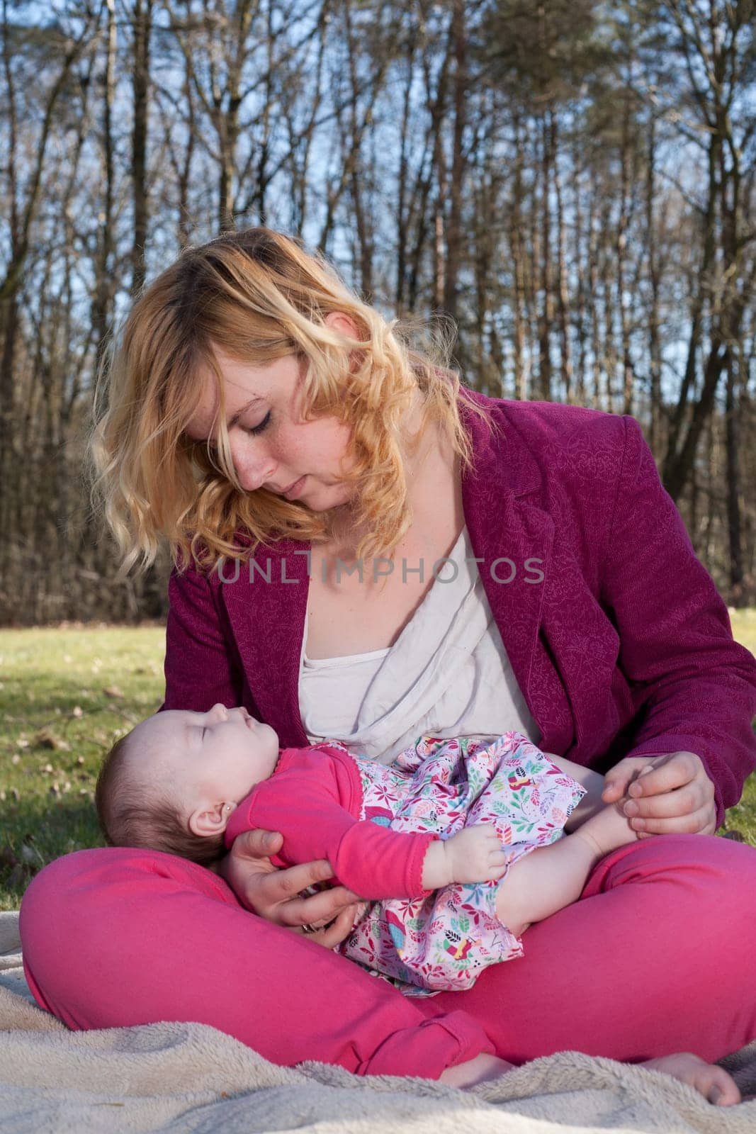 Young mother is having some nice time with her baby on a sunny day