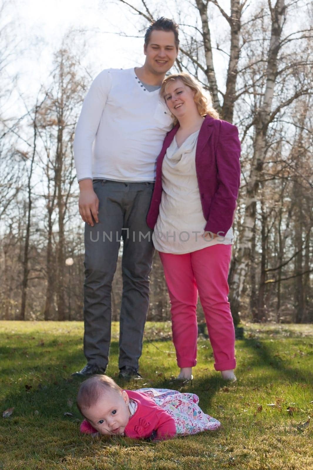 Young family is having  nice time with their baby on a sunny day