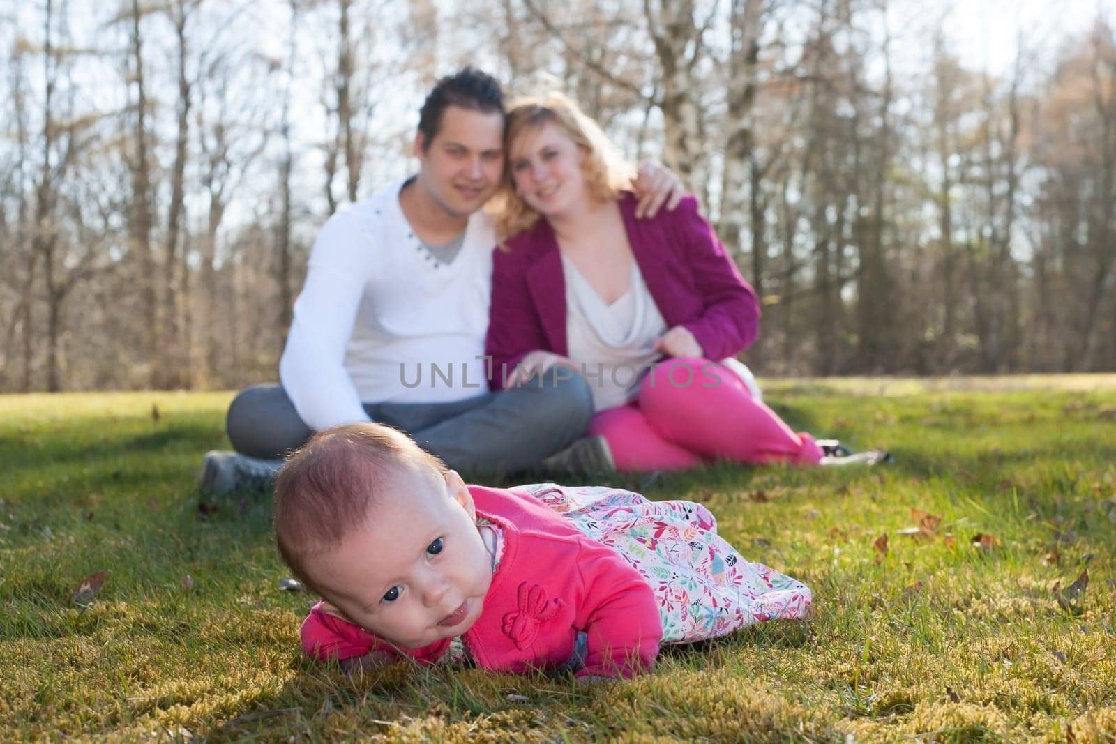 Young family is having  nice time with their baby on a sunny day