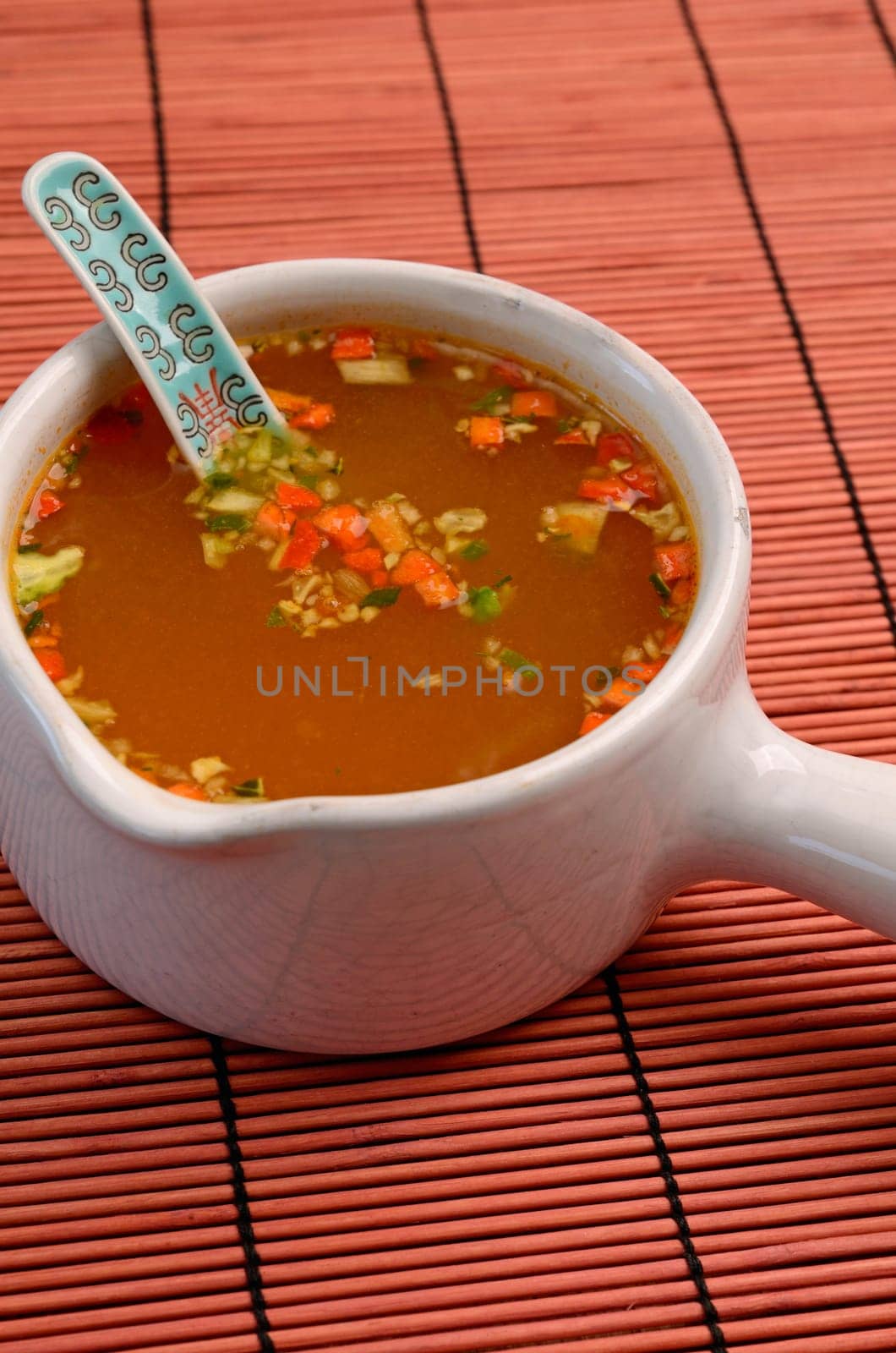 Asian soup an a bamboo mat