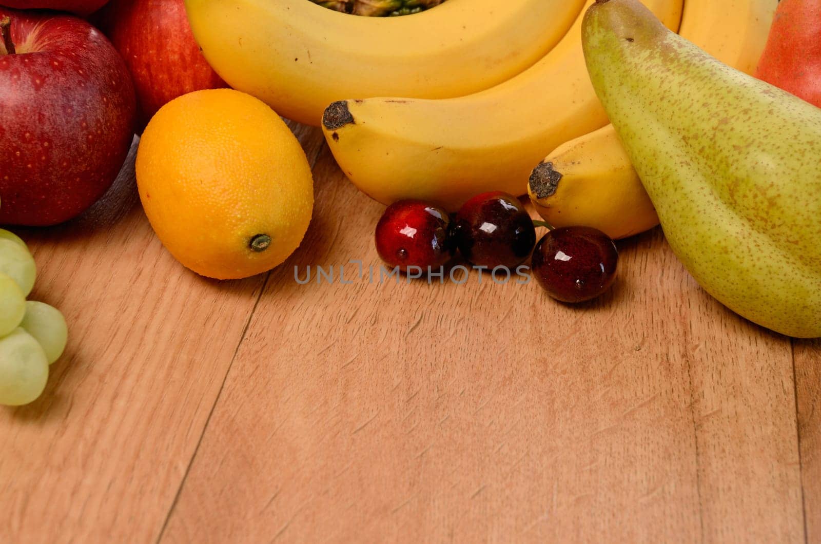 Fresh fruits on a wooden background