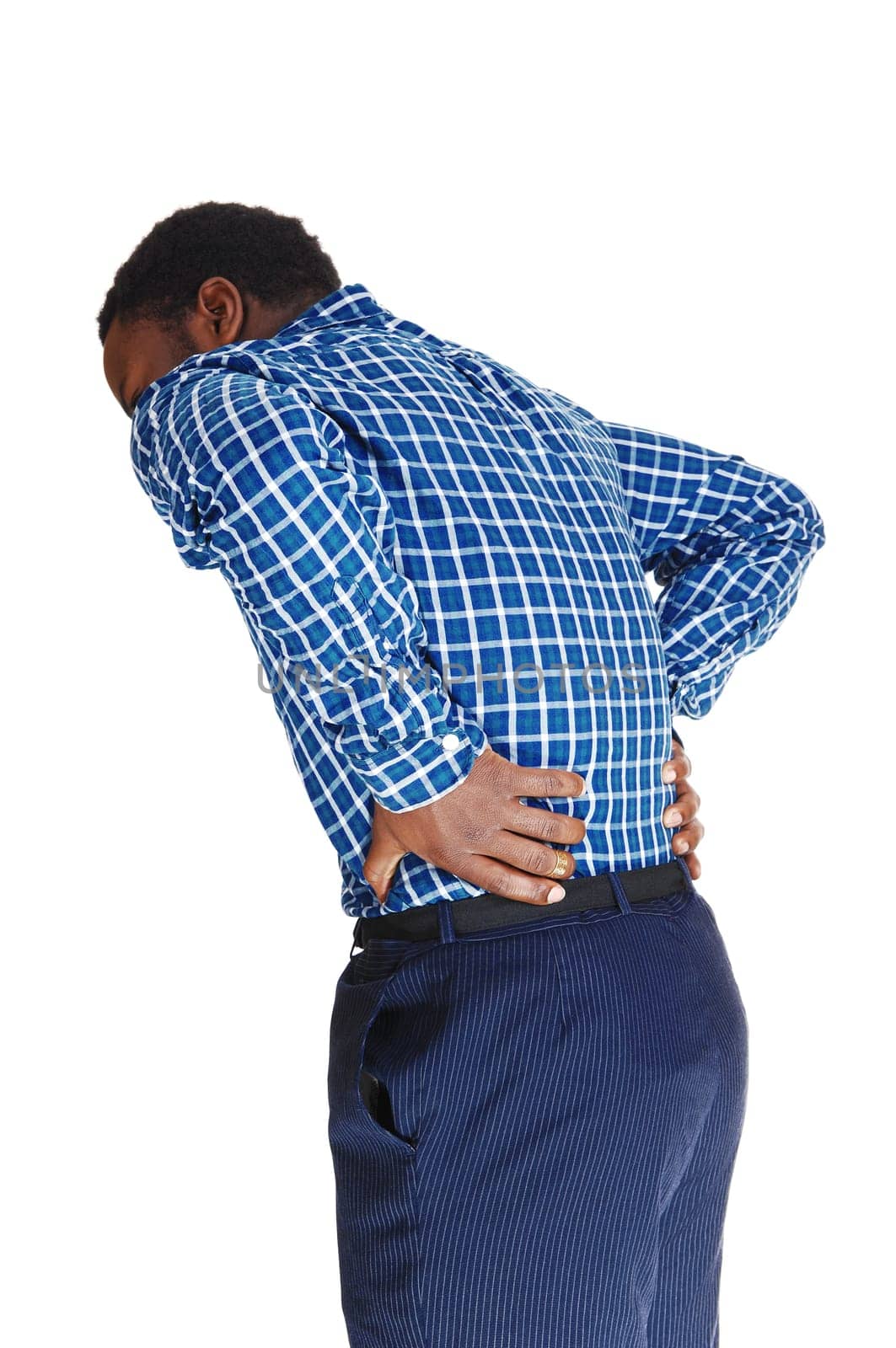 A young black man standing isolated for white background, holding his .hands on his back for heavy back pain..