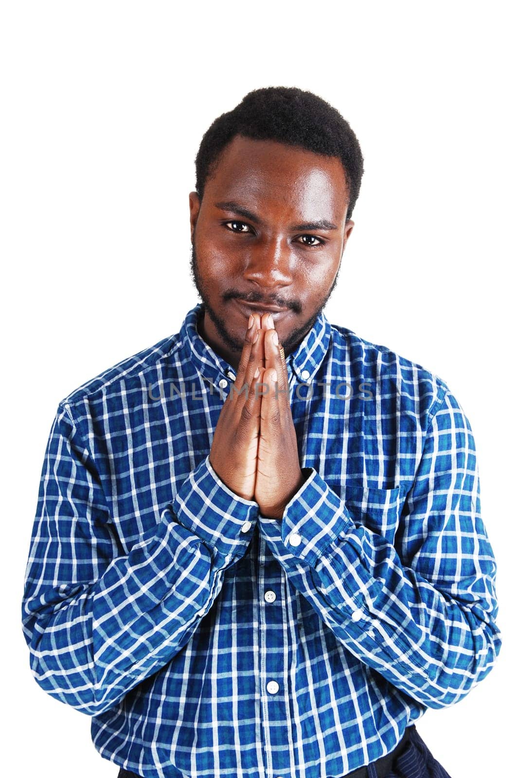 A young black man standing isolated for white background, folding his hands .and praying..
