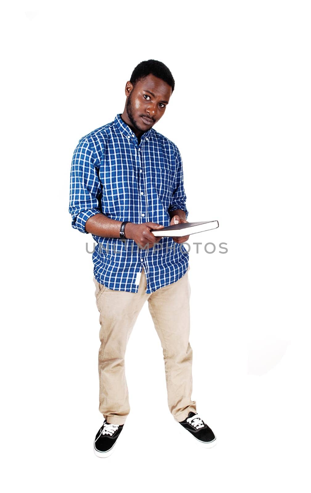 A protract picture of a black man in a blue shirt standing and holding a book .in his hands, isolated for white background..