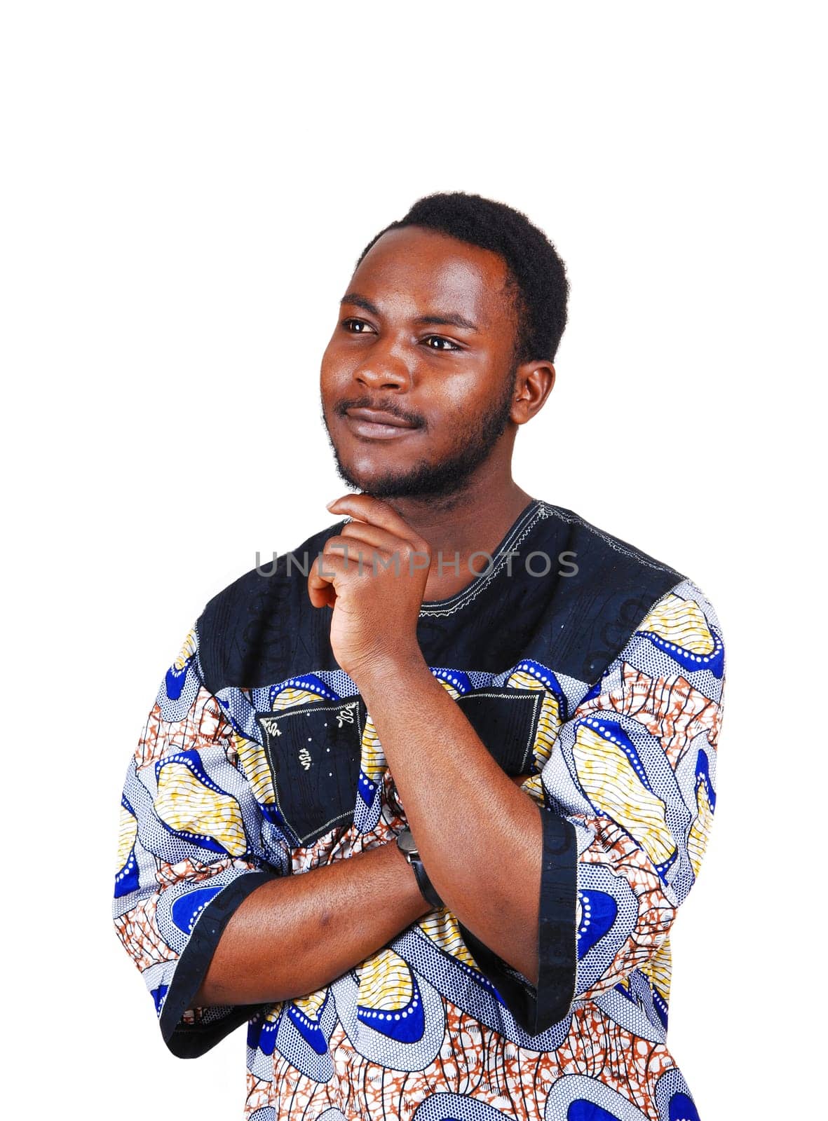 A handsome young black man in a colorful shirt and his hands in his.shin, looking up isolated for white background..