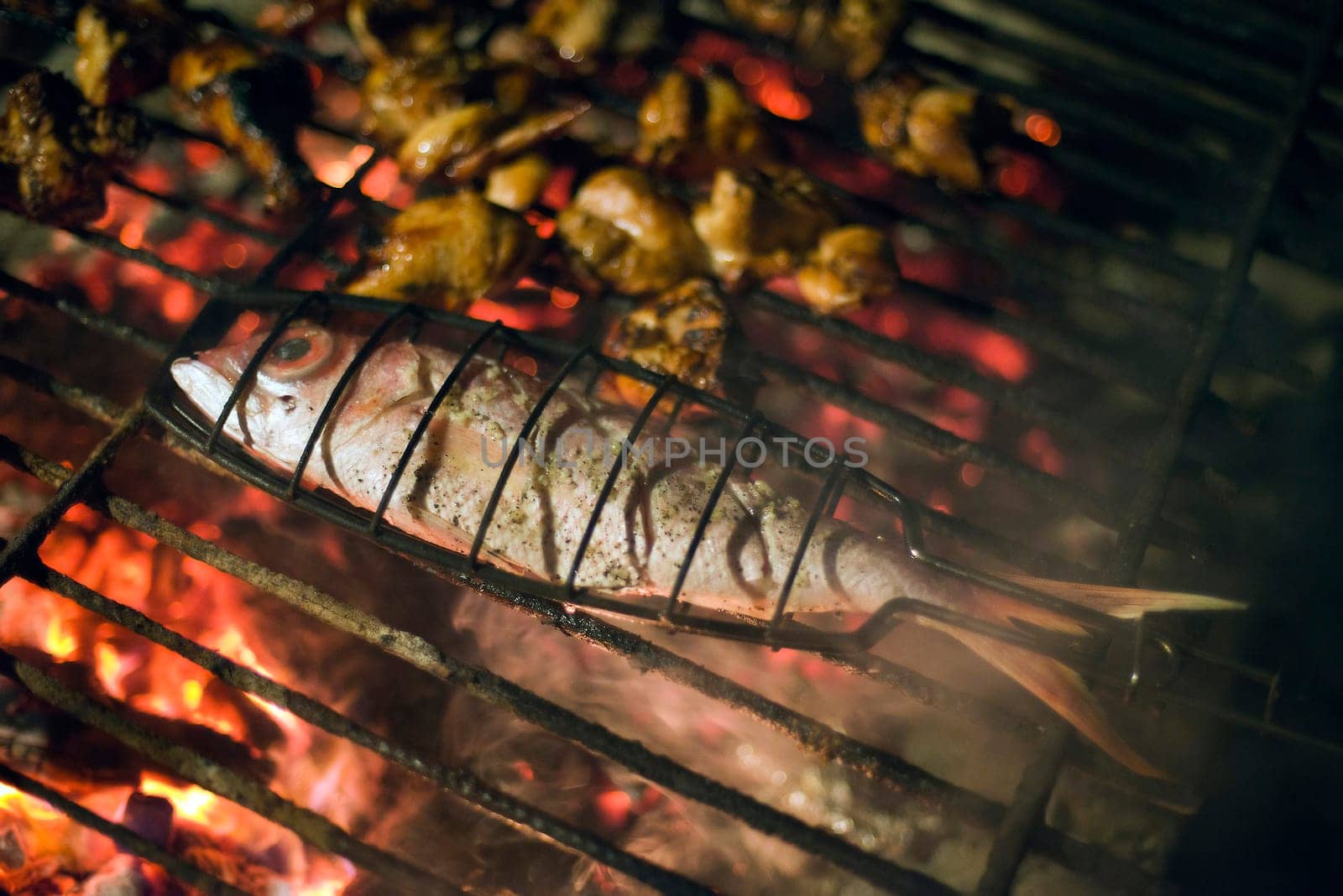 Fresh sea fish on grill close up shoot