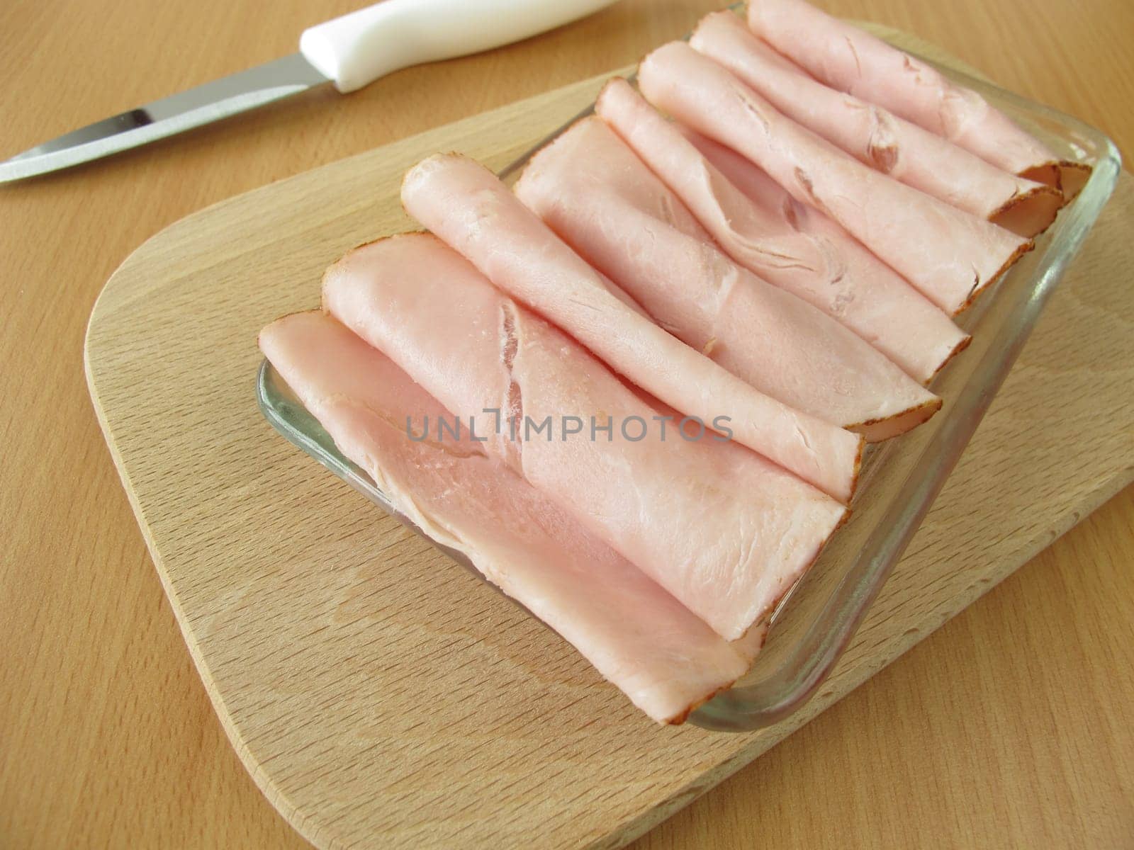 Cooked ham on a small glass plate