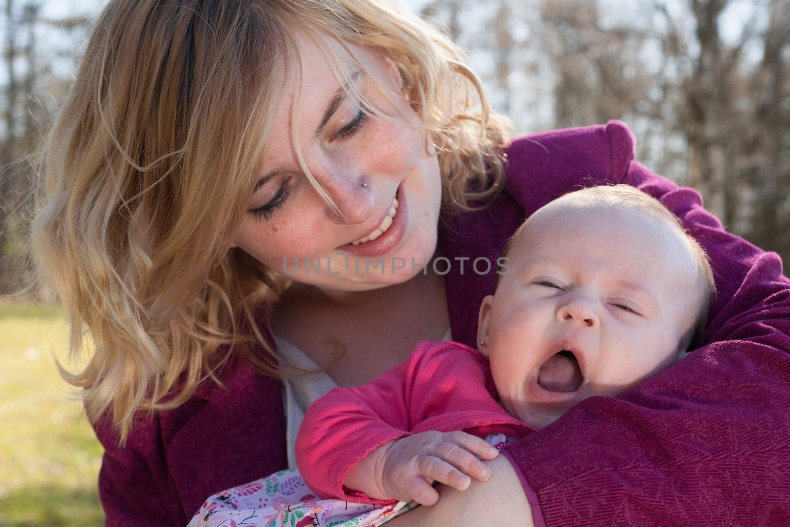 Young mother is having some nice time with her baby on a sunny day
