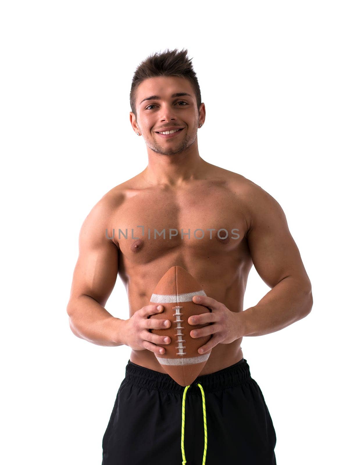 Muscular american football player shirtless with ball in hands, isolated on white