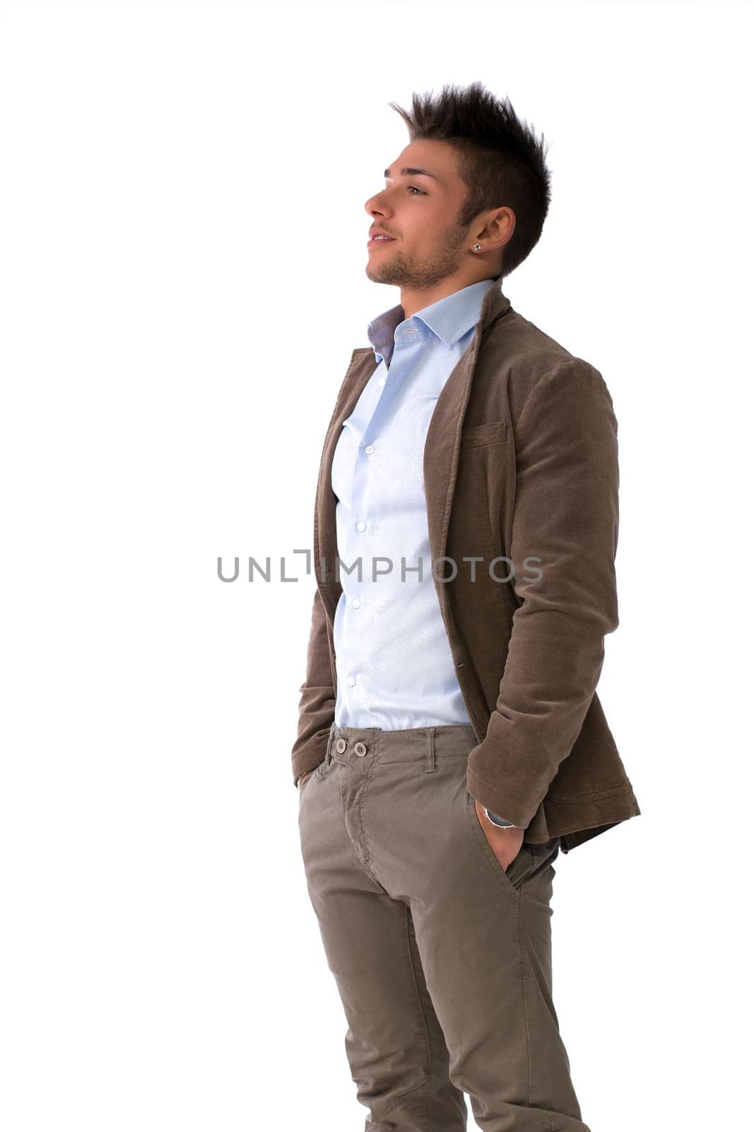 Handsome young man portrait, standing isolated on white, profile position