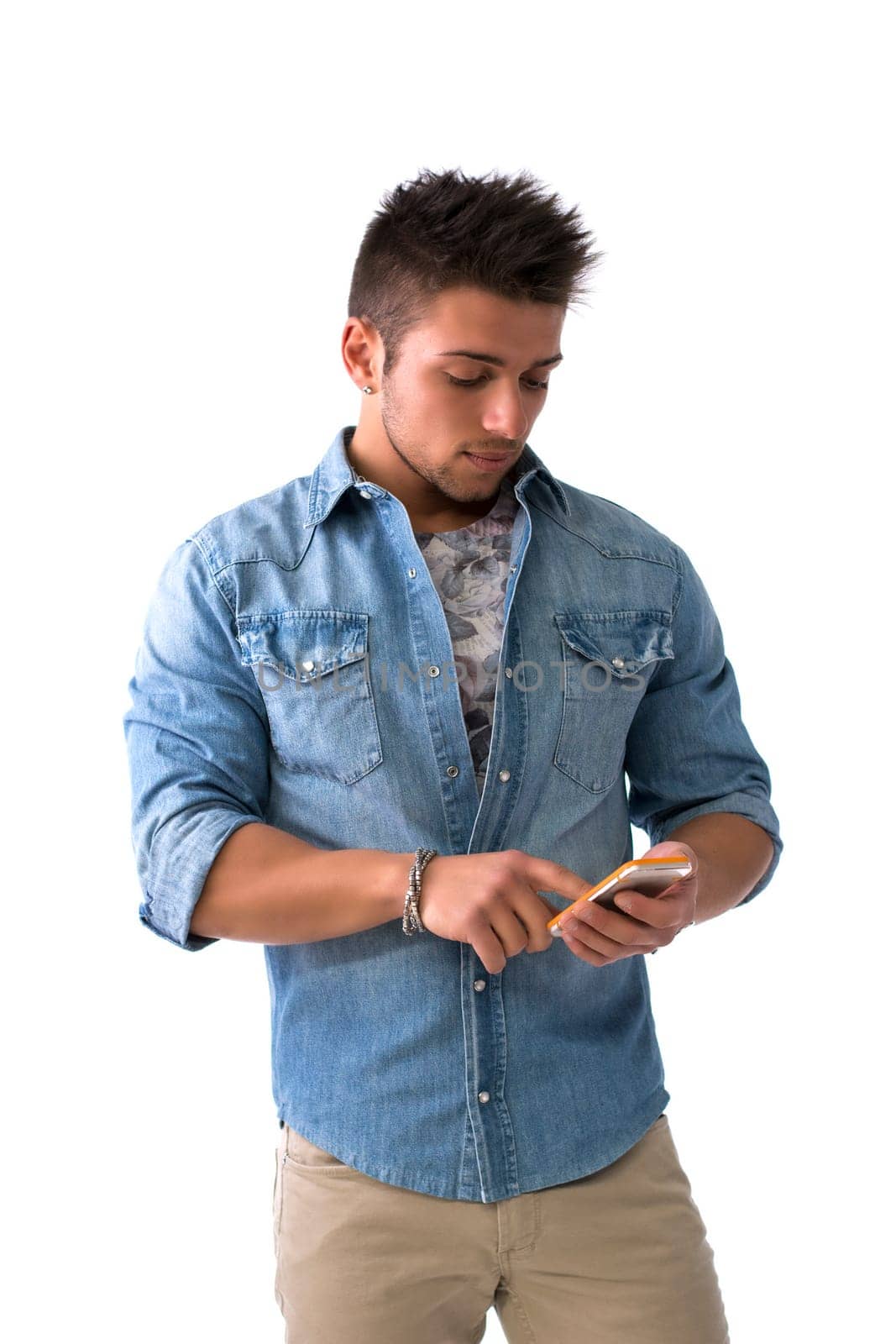 Attractive young man typing on smartphone, sending text message, isolated on white