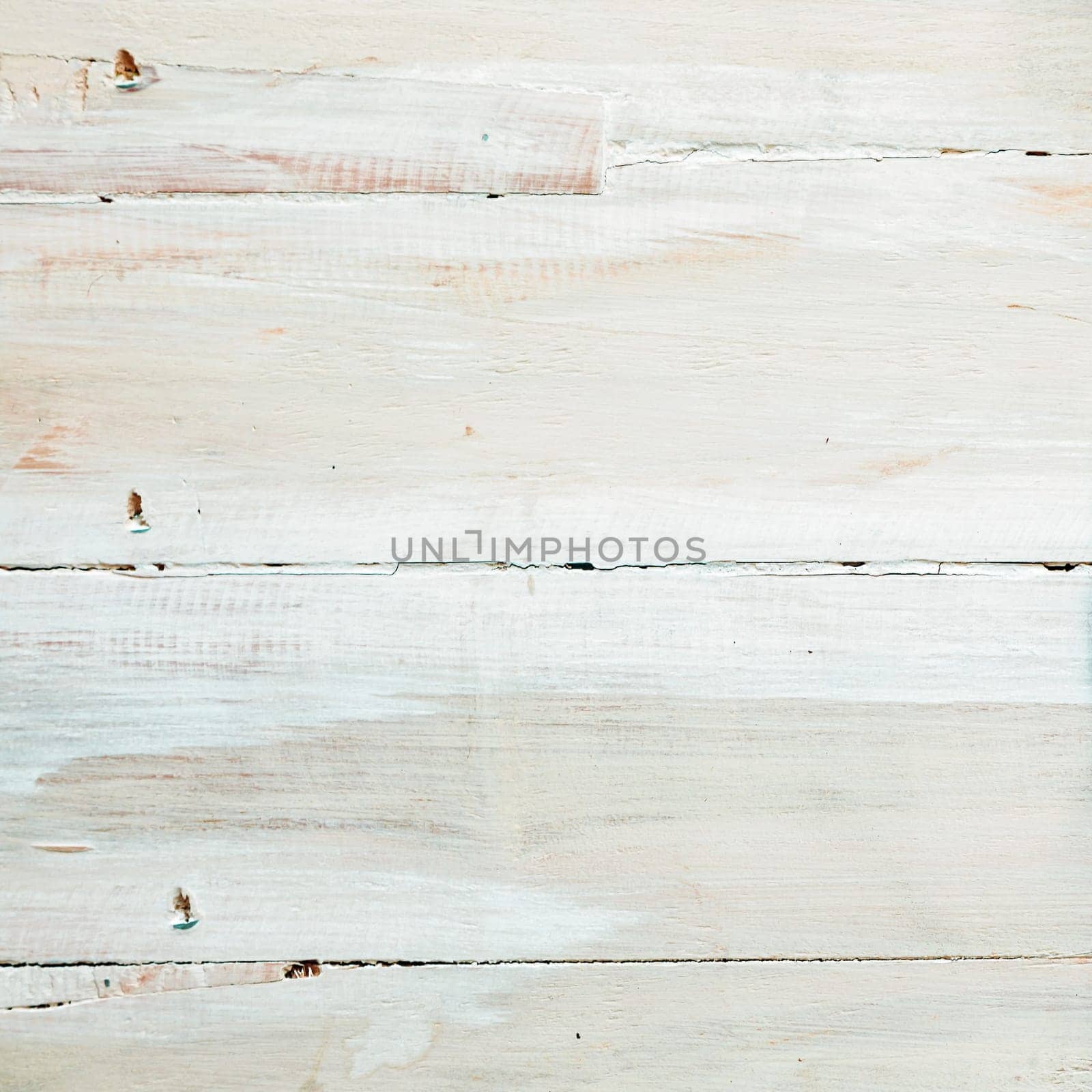 Background texture of painted or whitewashed white wooden boards with a mottled brushstroke pattern in square format with copyspace for your text
