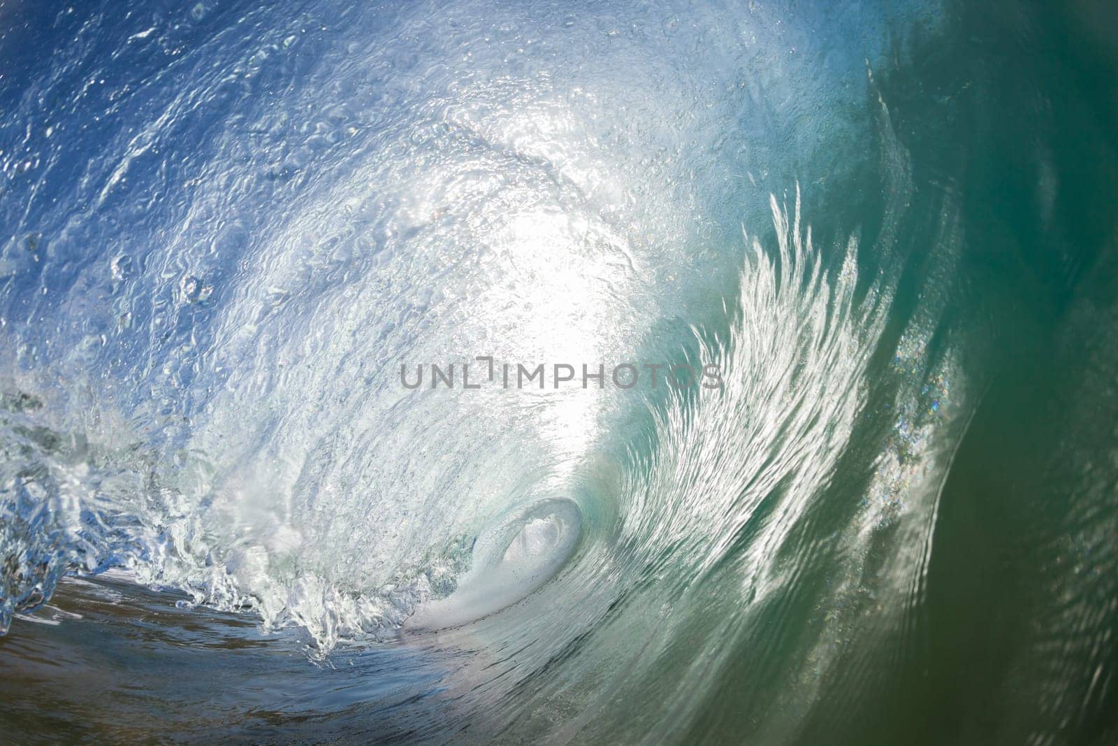 Ocean wave crashing water power energy on shallow reefs nearby beach coastline