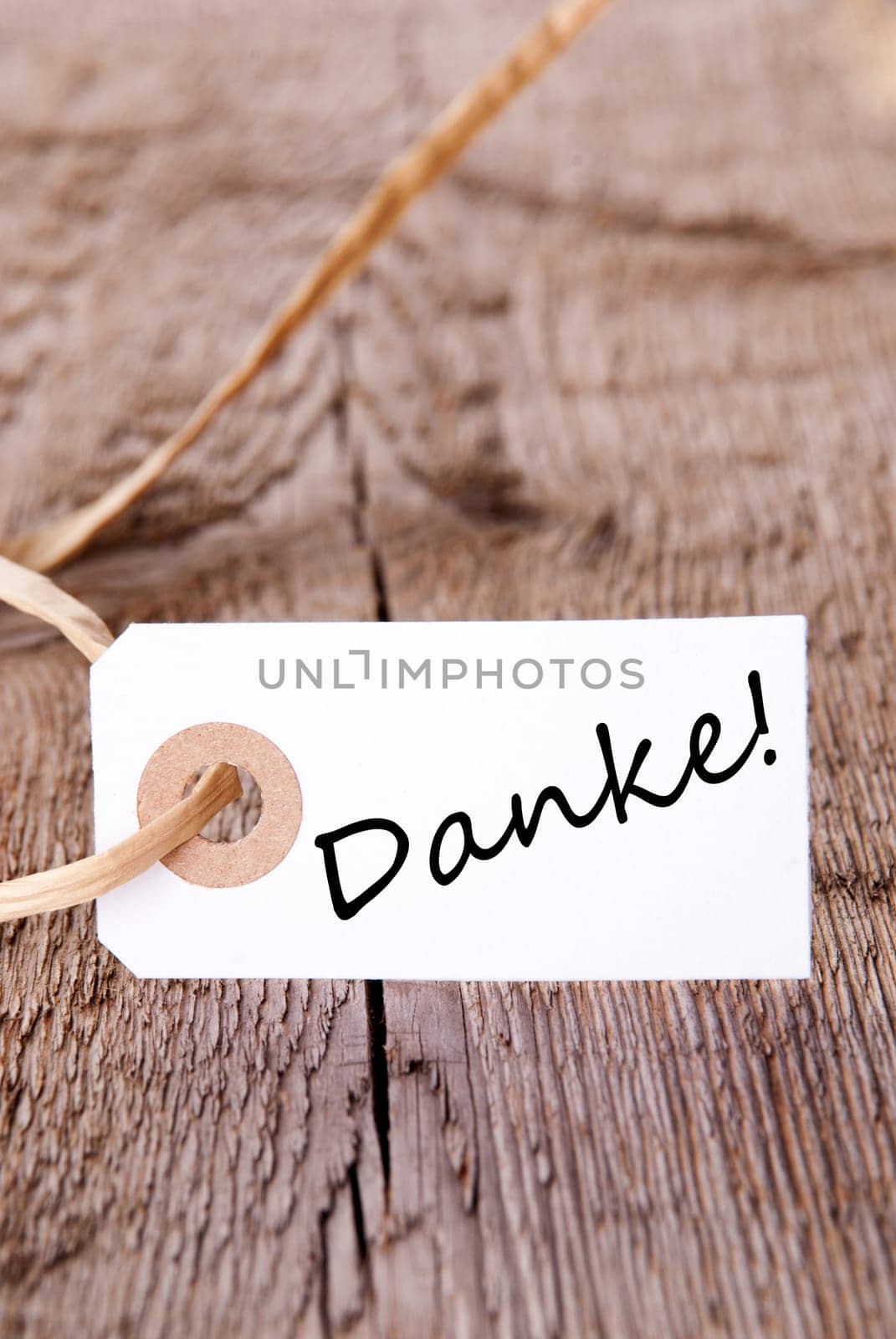 Tag with the German Word Danke, which means Thanks, on a wooden Plank