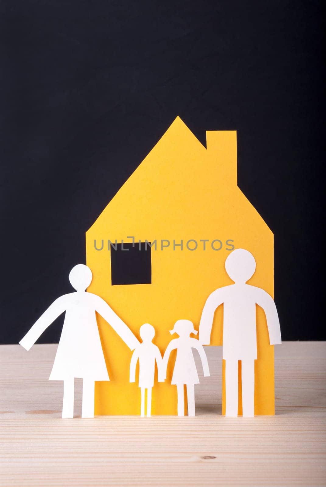 White Paper Chain Family with their House in front of a black Background