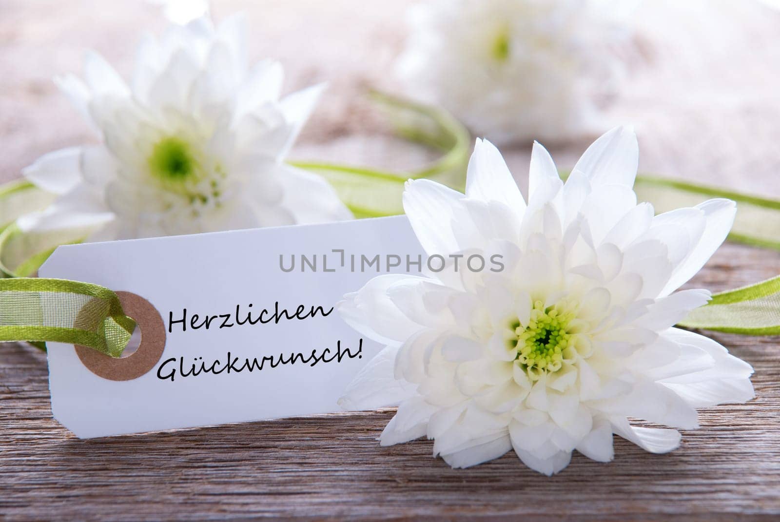 White Banner with the German Words Herzlichen Glueckwunsch which means Congratulations