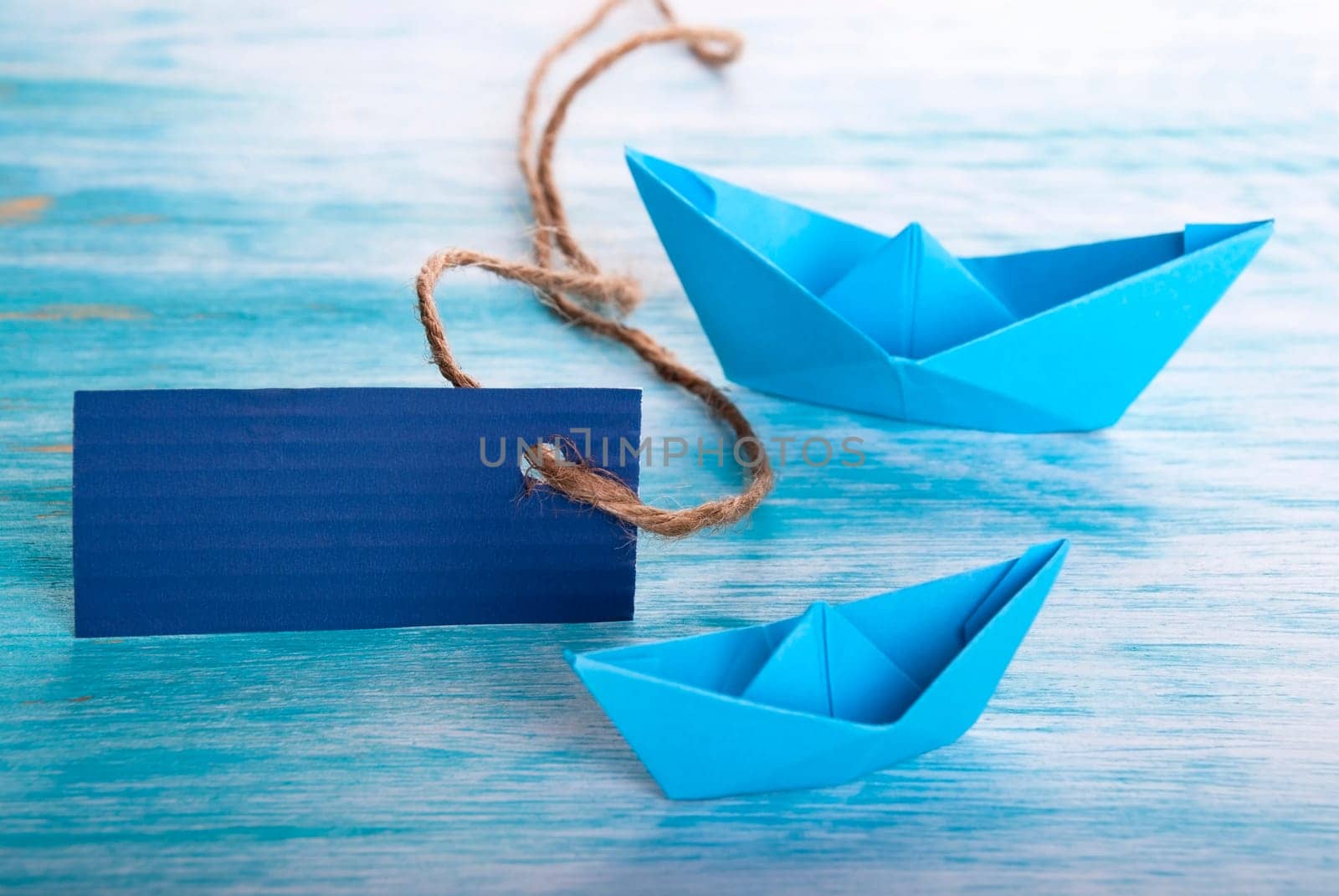 Empty Dark Blue Tag with two Origami Boats, Copyspace