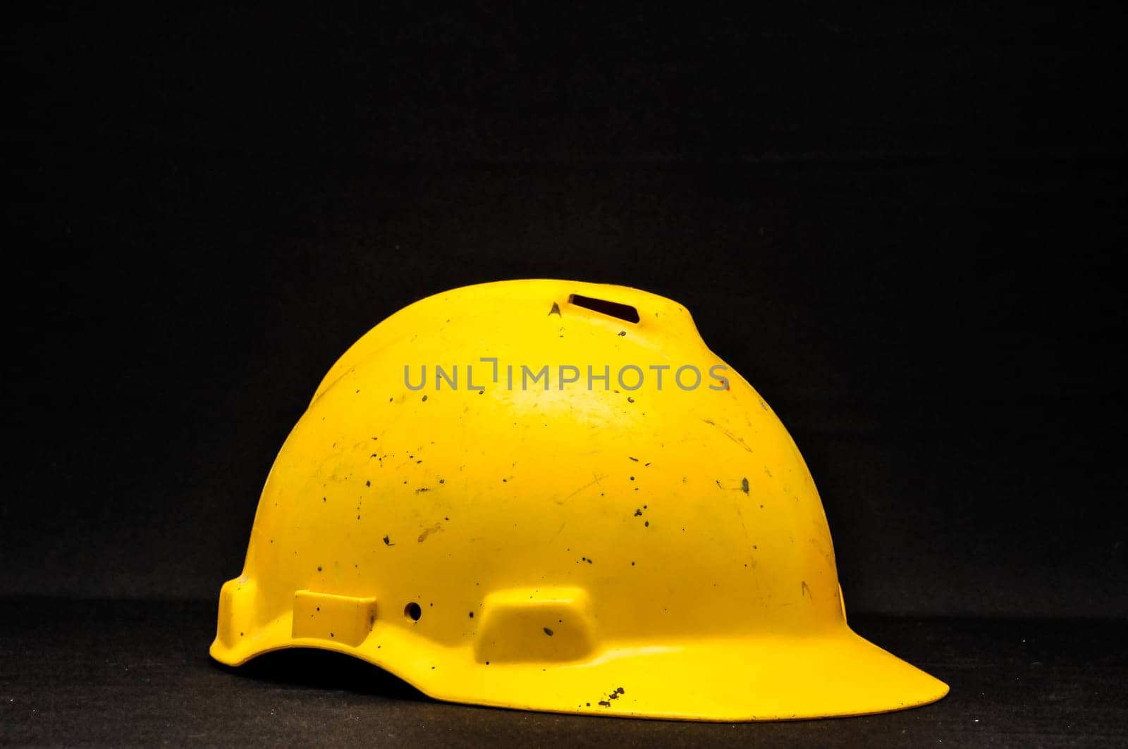 Yellow Safety Helmet on a Black Background