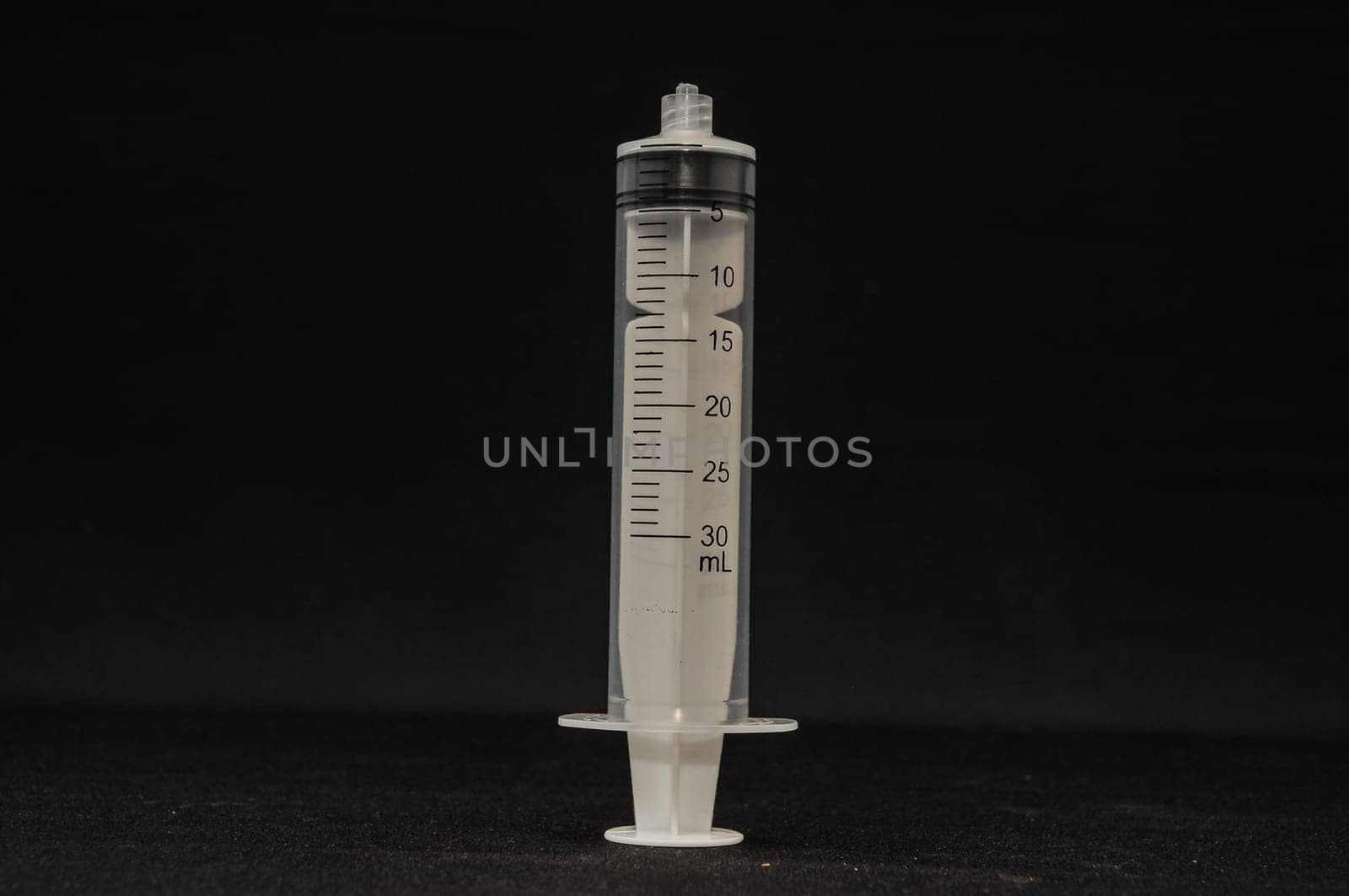 Black and White Syringe on a Dark Background