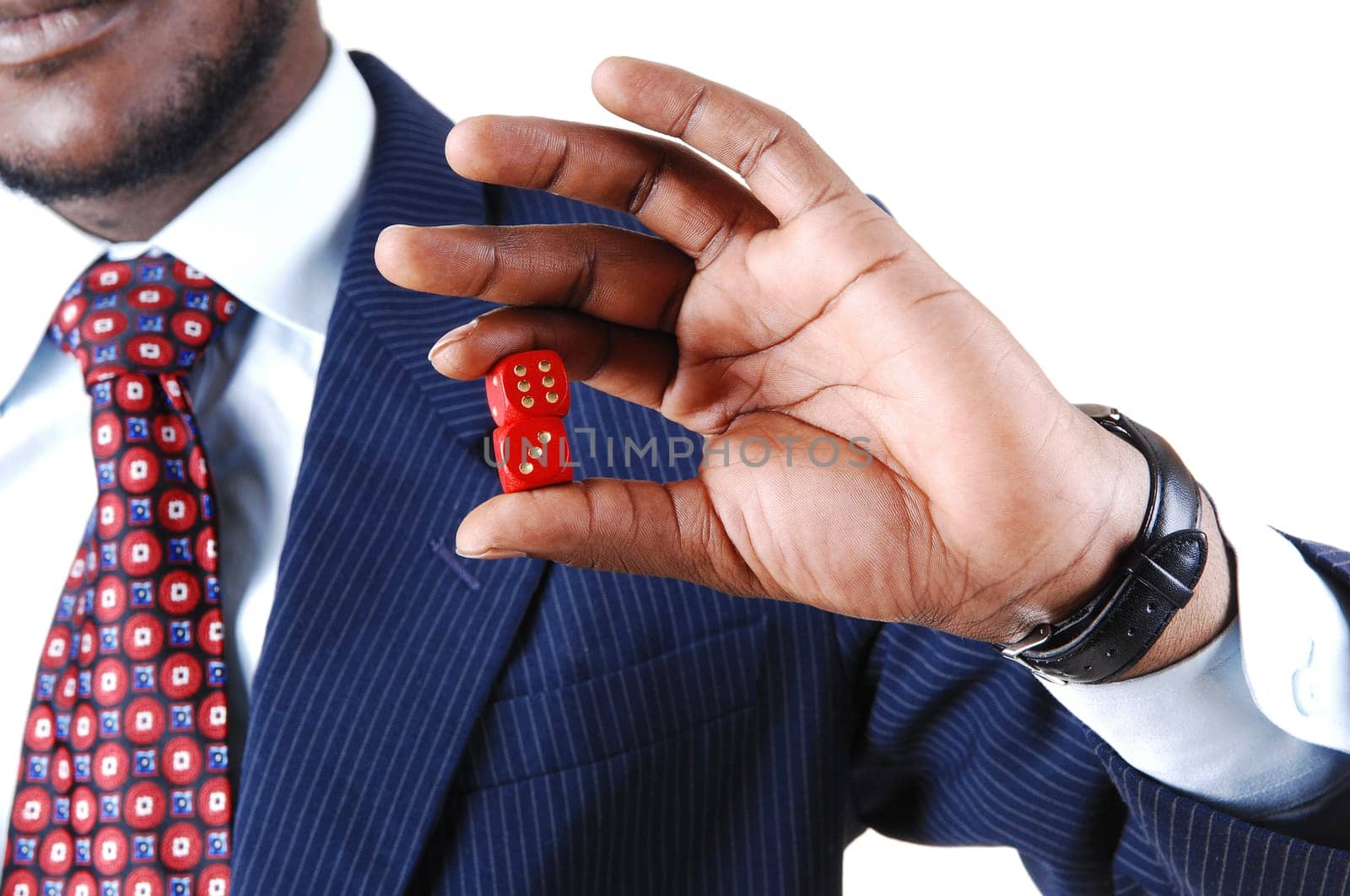 A black businessman holding two red dice in his hand, in a blue suit.standing isolated for white background in closeup..