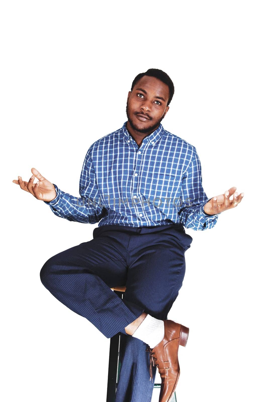 A black young black man sitting isolated for white background showing .with his hand he do's not know..