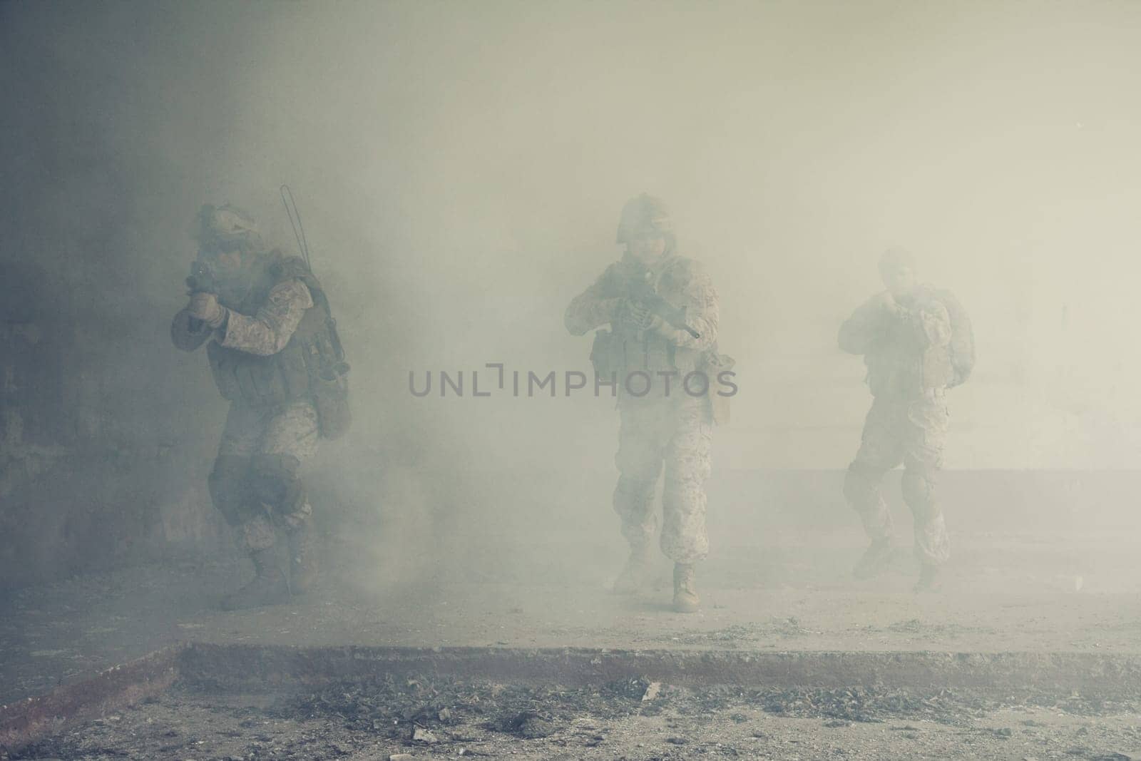 Squad of US marines in action in ruined building