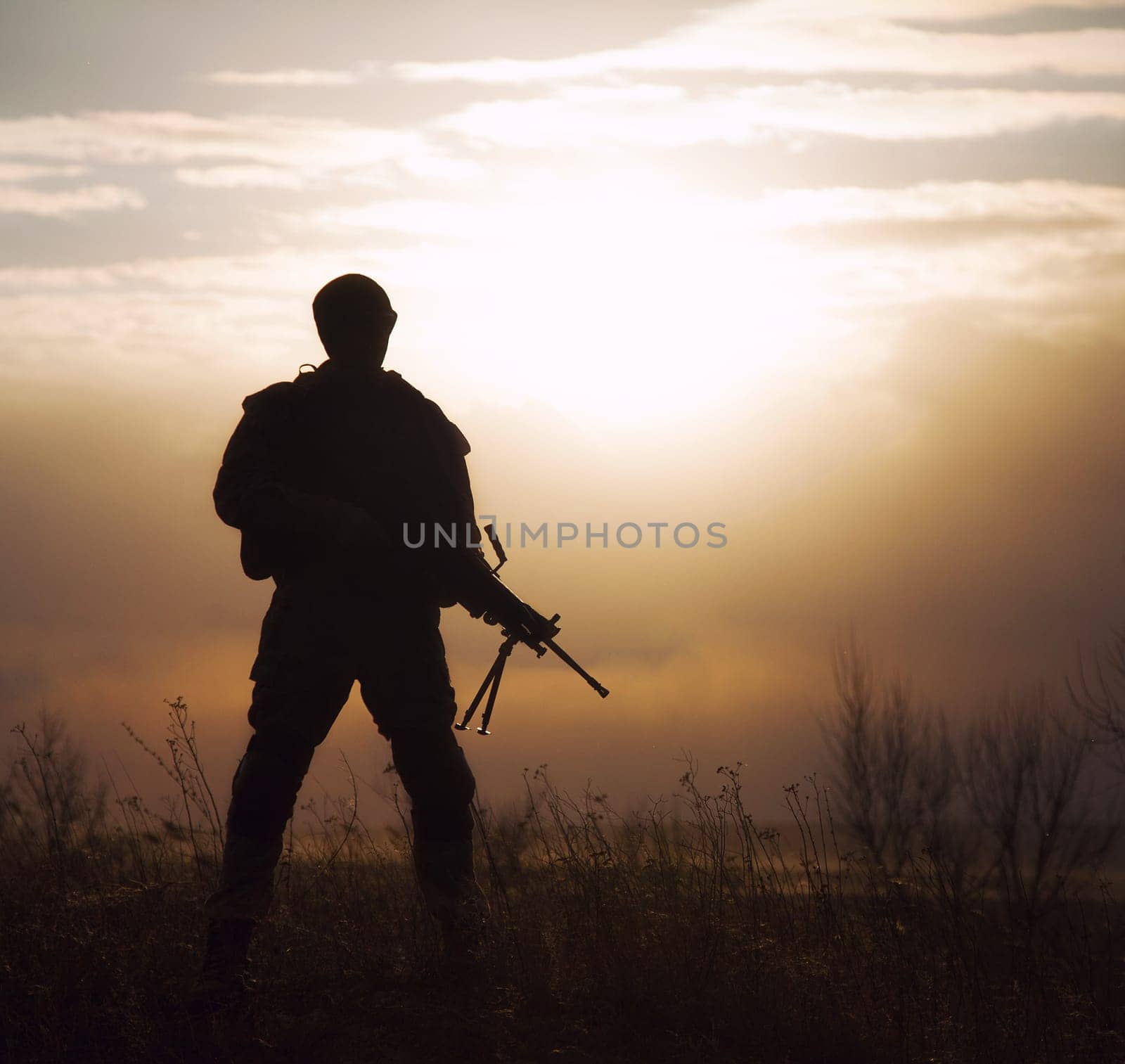 Silhouette of US marine with rifle against the sunset
