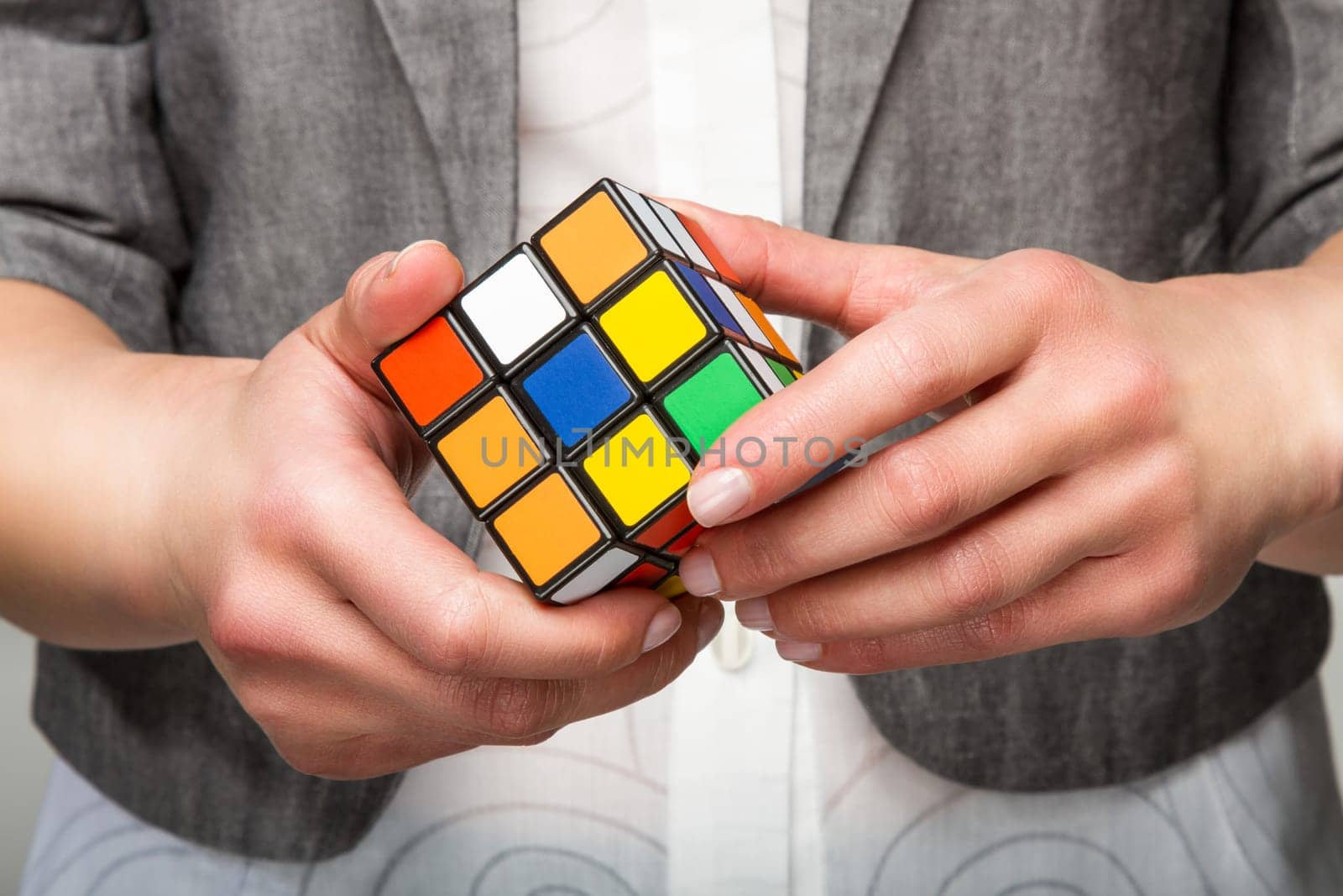 Hands holding or playing color cube game for concept solve solutionsolding color cube