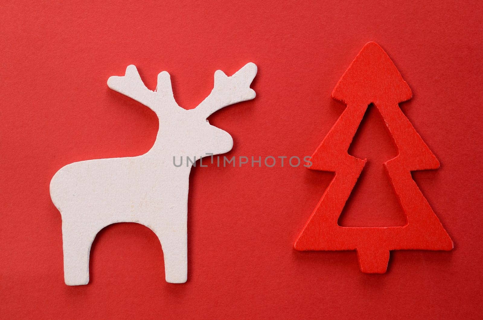 Christmas background with reindeer and tree on red