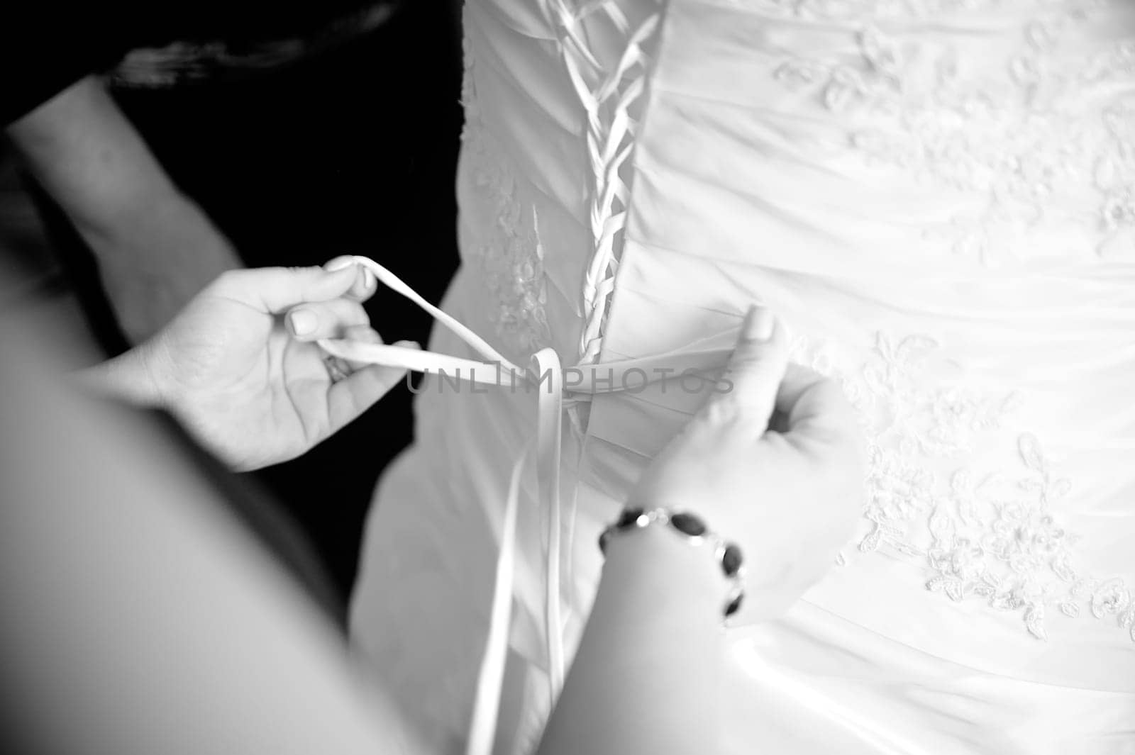 Bridesmaid helping to dress up in black and white