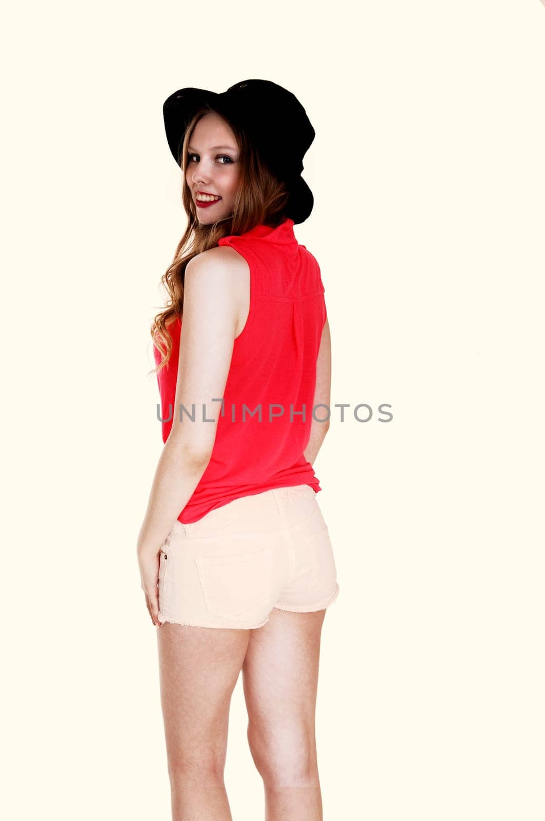A lovely young woman standing in shorts and hat from the back,.isolated for white background..