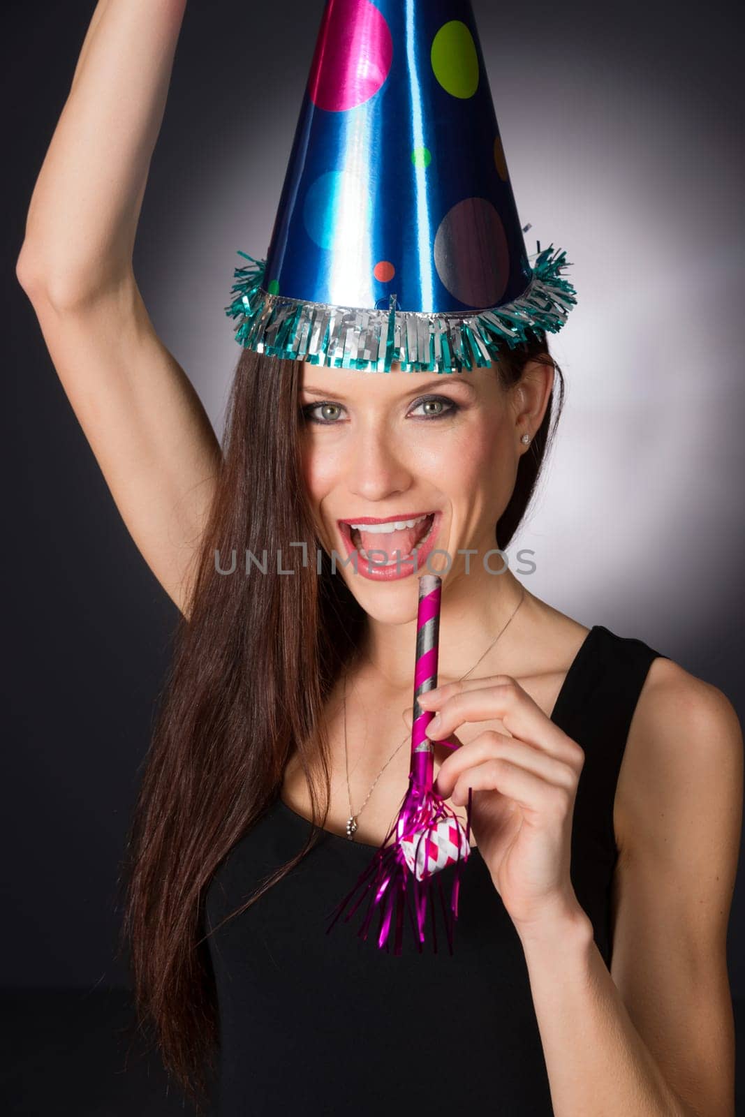 Beautiful woman at party waiting to make noise at midnight