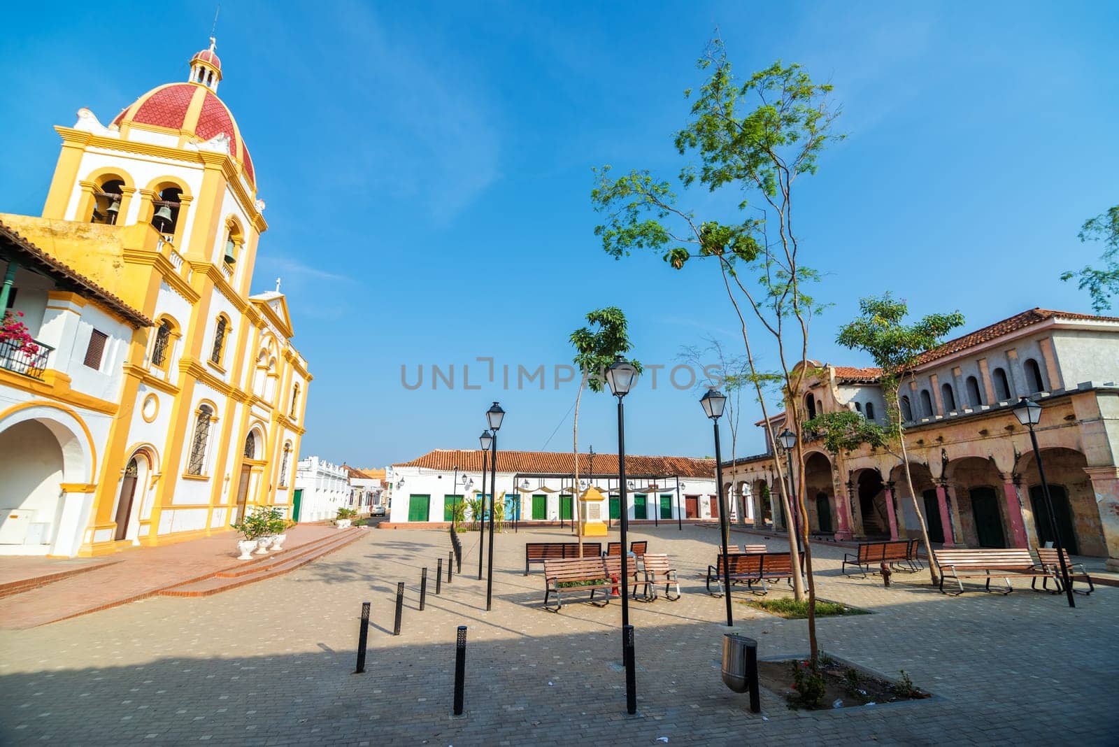 Plaza in Mompox, Colombia with a cathedral and old abandoned market