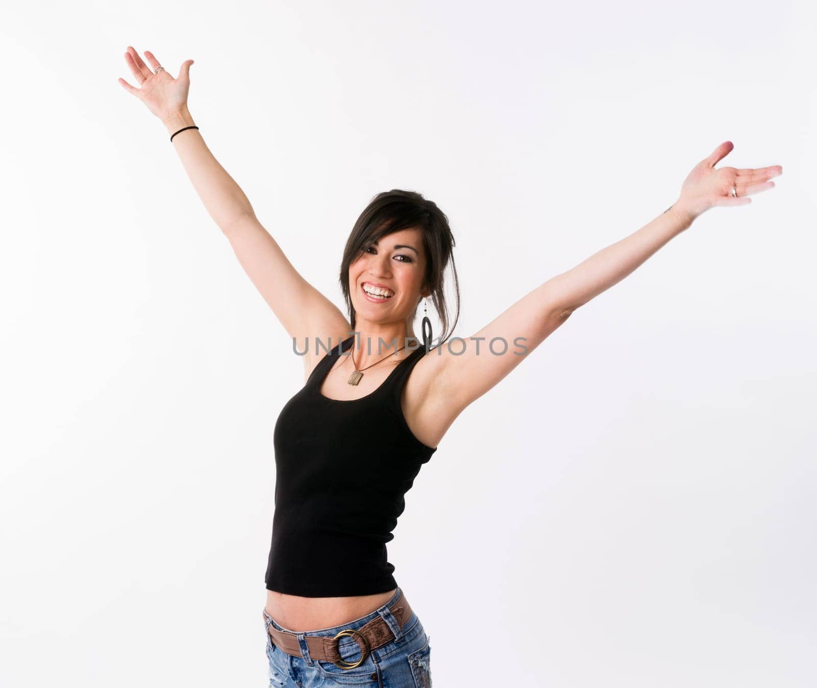 Woman motions towards the sky arms outstretched