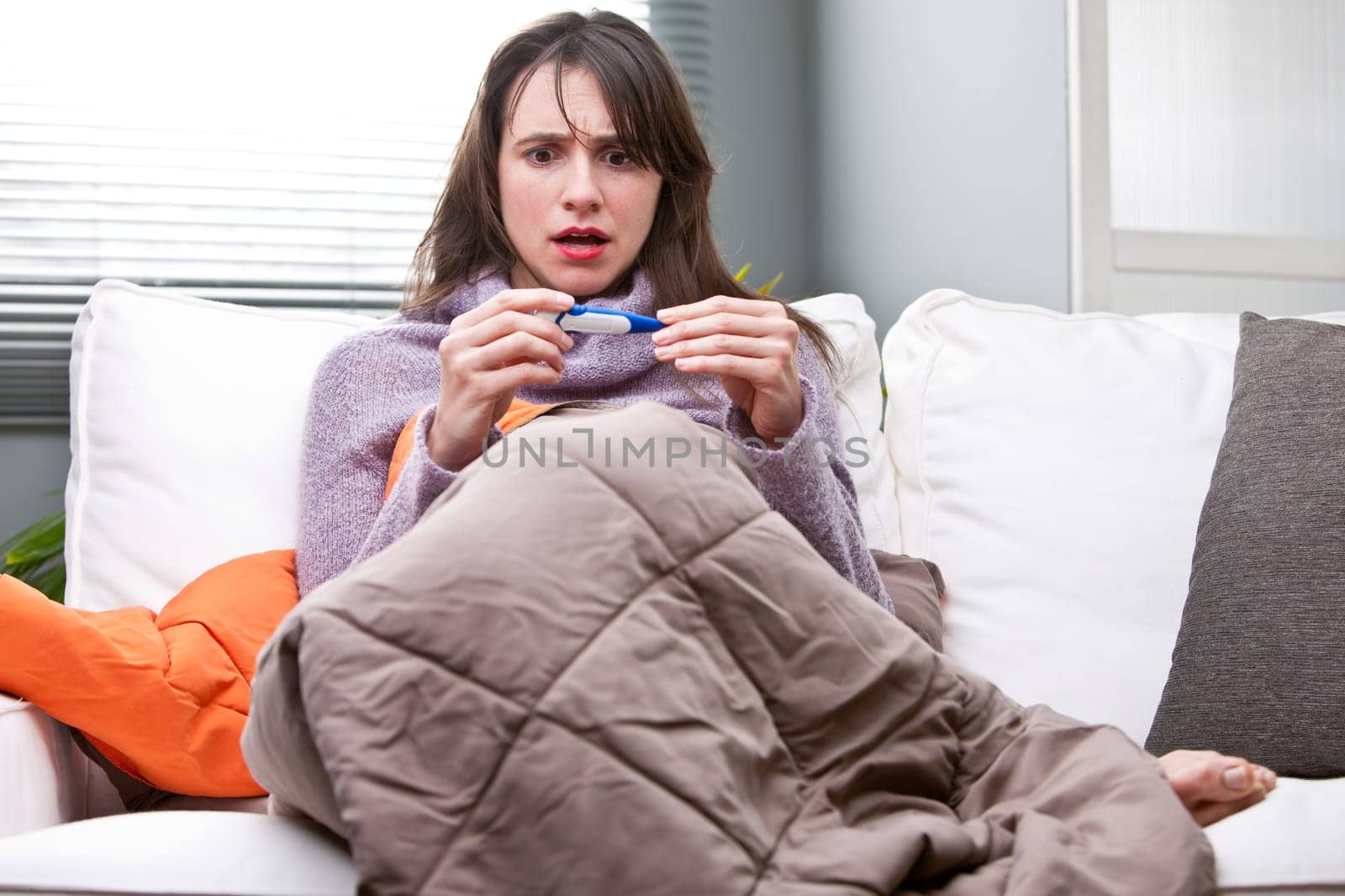 the girl is sad because she views on the thermometer that she has a bad temperature