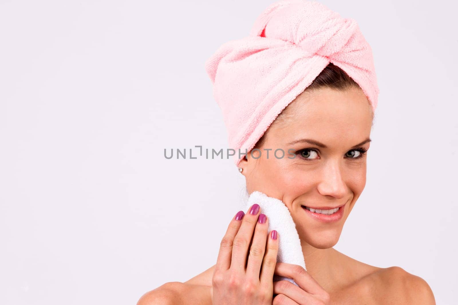 Beautiful woman just out of the shower wearing towel on her head