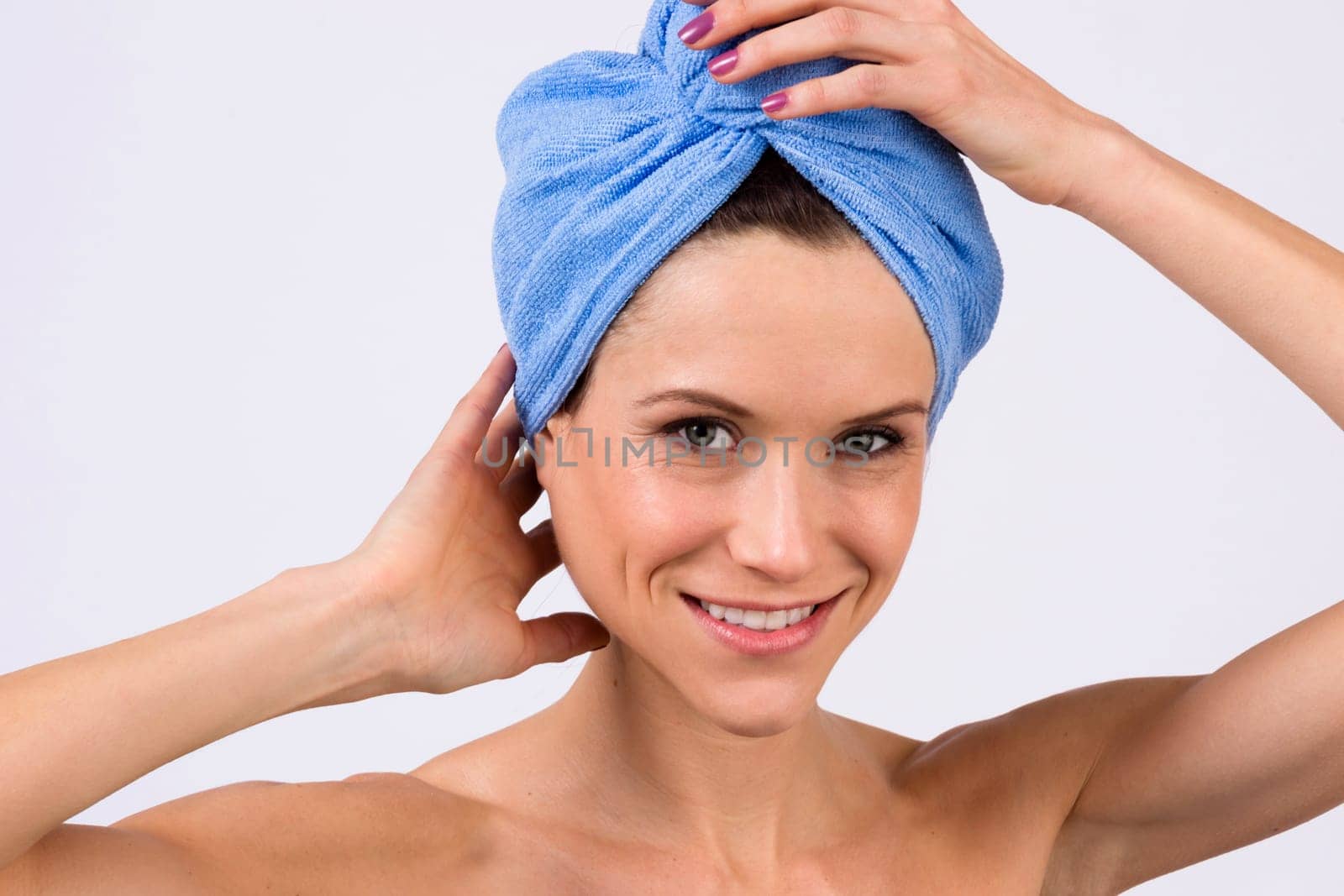 Beautiful woman just out of the shower wearing towel on her head
