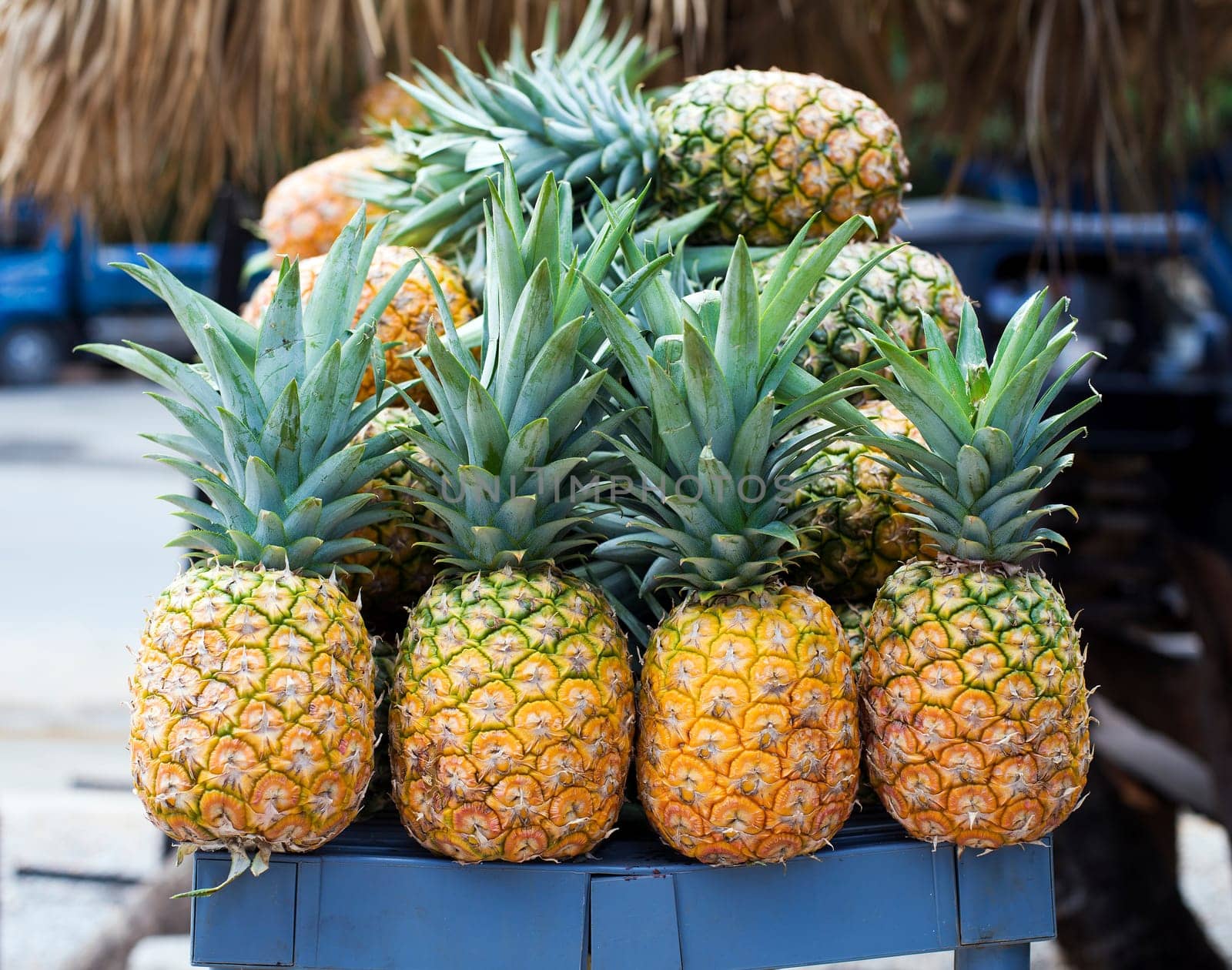 Pile of pineapples at street market, closeup