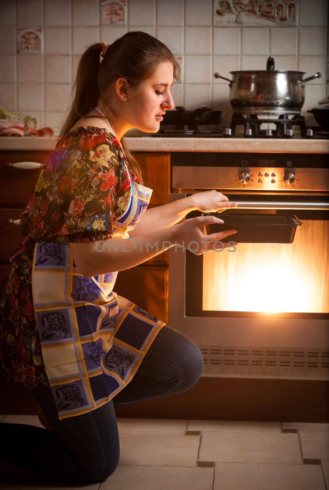 Closeup photo of housewife cooking cookies in oven