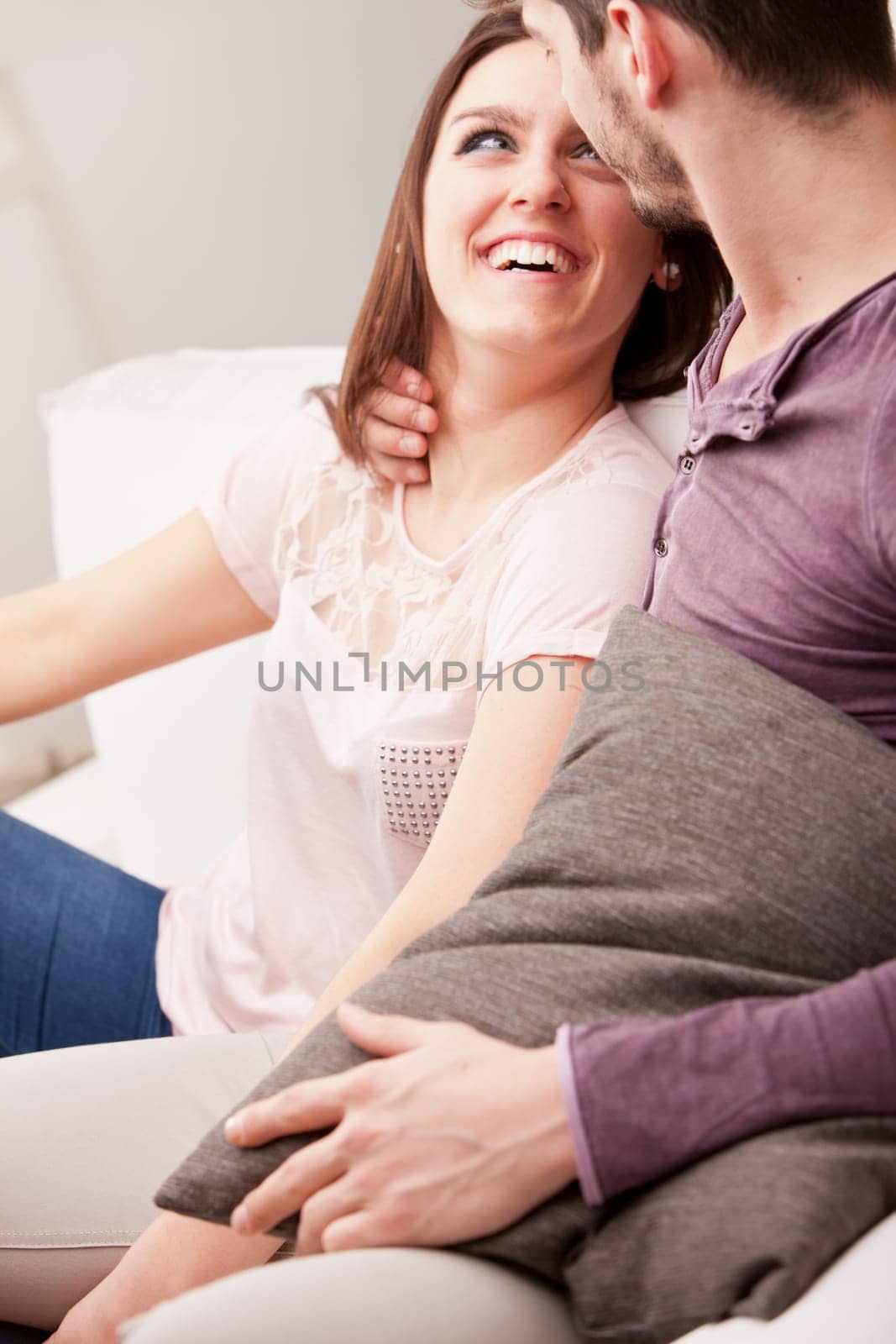 couple falling in love because she's looking at him with love while he holds her in his arms