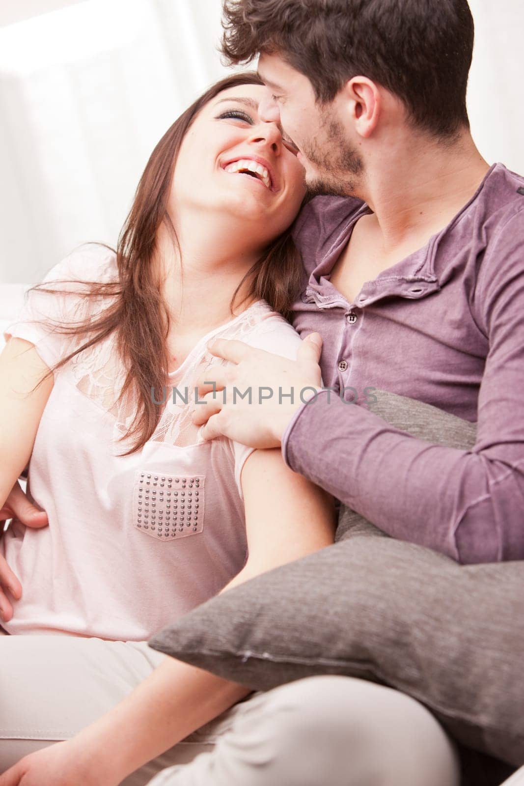 the girl smiles at him and he loves her while he holds her in his arms